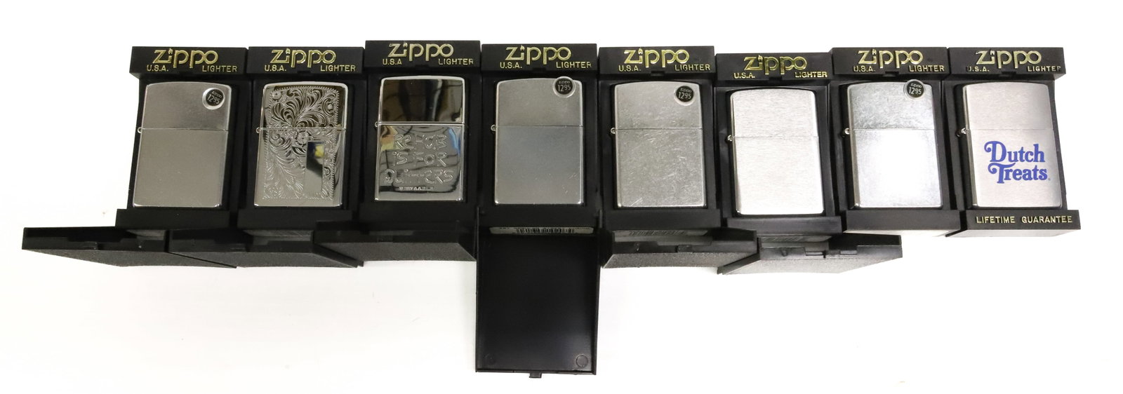 (8) Zippo Lighters, New in Boxes: Brushed and Engraved Metal. PLEASE READ CAREFULLY - ITEMS MUST BE PAID FOR THROUGH LIVE AUCTIONEERS OR WITH CASH OR CHECK IN PERSON - Terms for Purchasing and Shipping of Auction Items. Please read ca
