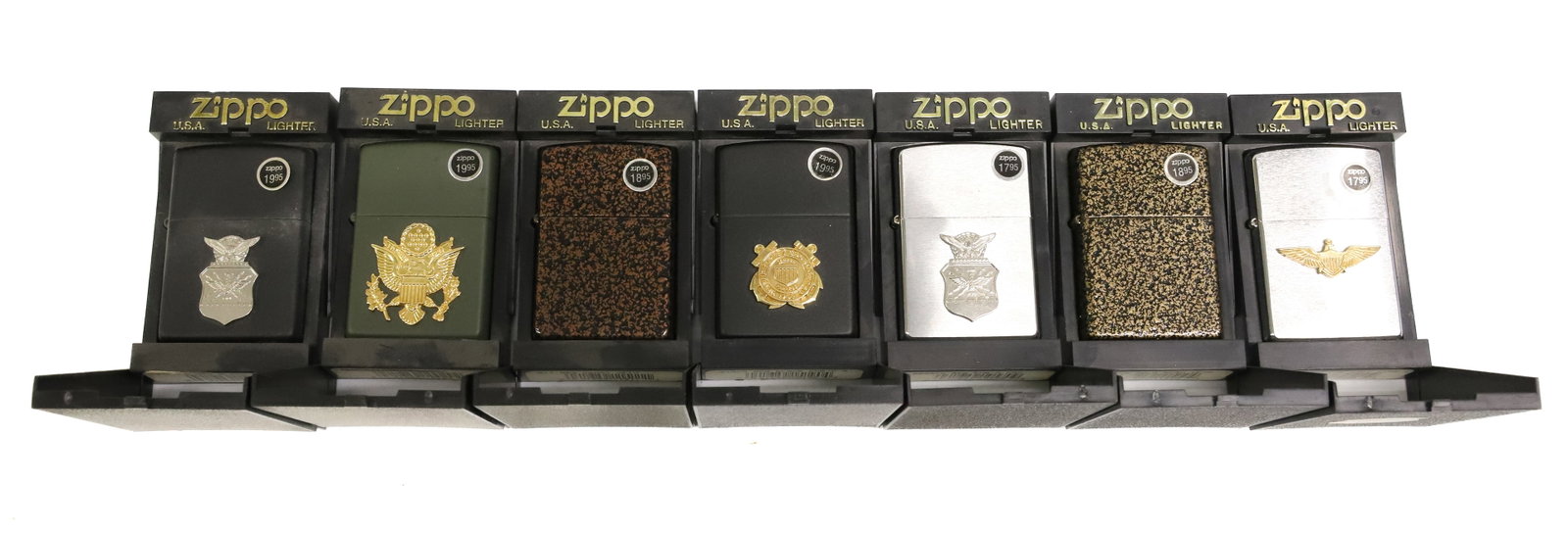 (7) Zippo Lighters, New in Box: Military Motifs and Textured Finishes. PLEASE READ CAREFULLY - ITEMS MUST BE PAID FOR THROUGH LIVE AUCTIONEERS OR WITH CASH OR CHECK IN PERSON - Terms for Purchasing and Shipping of Auction Items. Ple