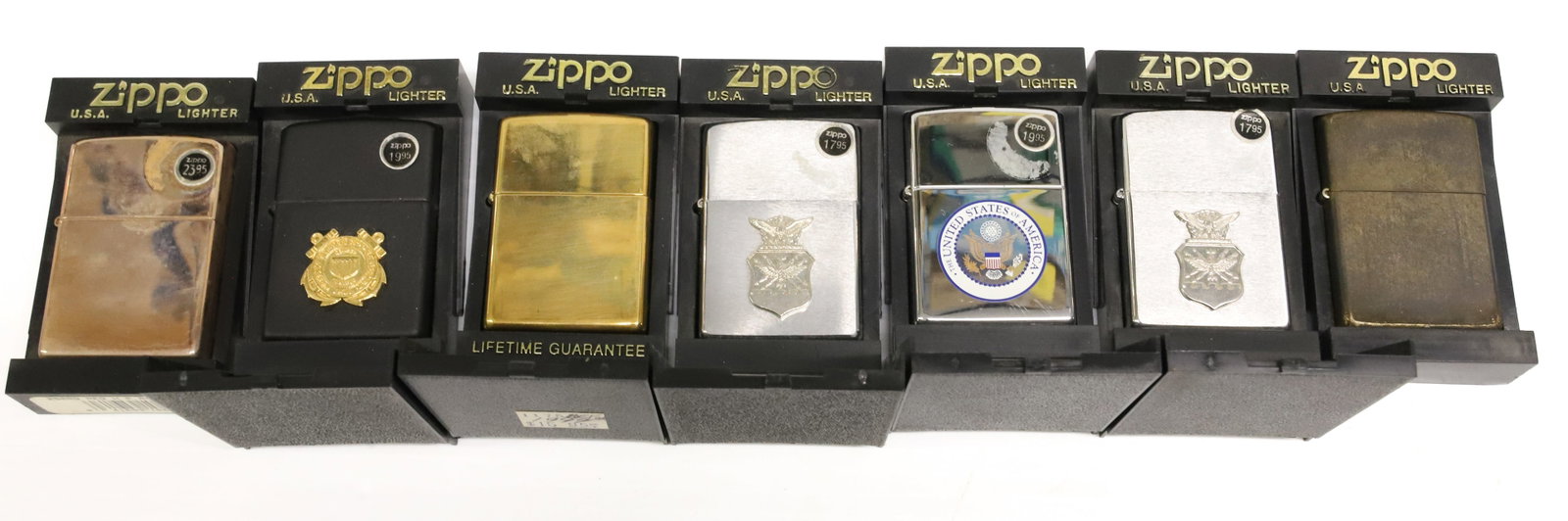 (7) Zippo Lighters, New in Box: Including: Military, Brass Finish and More. PLEASE READ CAREFULLY - ITEMS MUST BE PAID FOR THROUGH LIVE AUCTIONEERS OR WITH CASH OR CHECK IN PERSON - Terms for Purchasing and Shipping of Auction Items