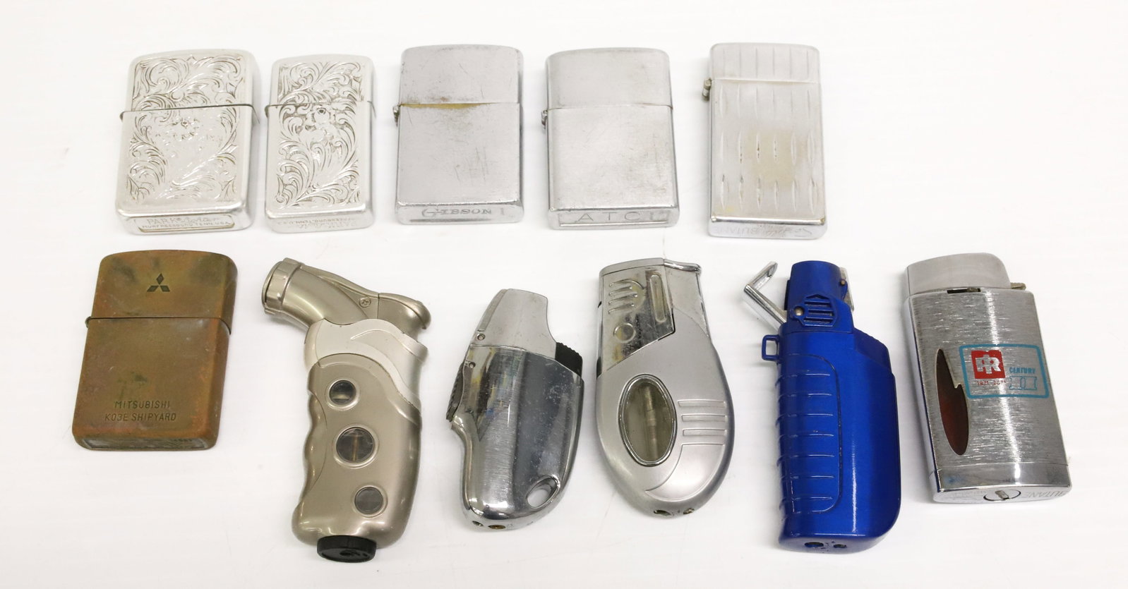 (11) Vintage Lighters: Including: Park Lighters, ATC, Clean Cut, Gibson, Scripto, China and More. PLEASE READ CAREFULLY - ITEMS MUST BE PAID FOR THROUGH LIVE AUCTIONEERS OR WITH CASH OR CHECK IN PERSON - Terms for