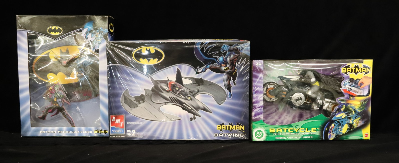 Lot of (3) Batman Toys: Including: Batwing Model by Ertl, Batcycle (Mattel) and Batman Pendulum Clock (WB). Model sealed in plastic. PLEASE READ CAREFULLY - ITEMS MUST BE PAID FOR THROUGH LIVE AUCTIONEERS OR WITH CASH OR CHE