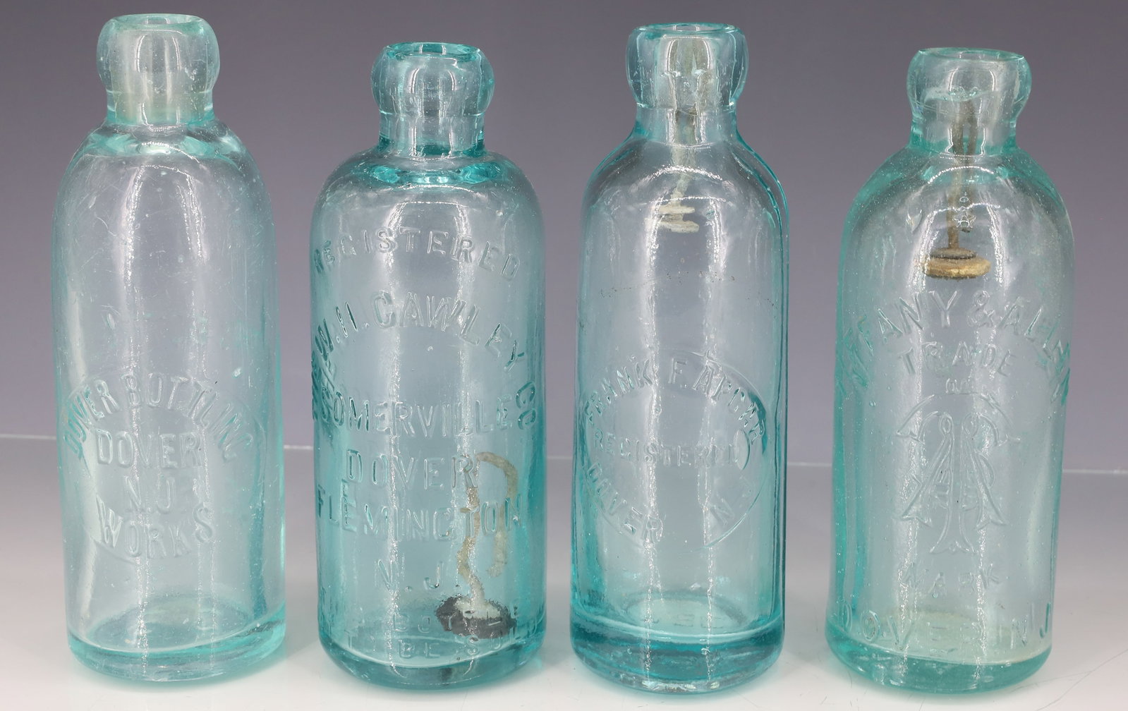 (4) DOVER, NJ BOTTLES: HUTCHINSON BOTTLES INCLUDING: TIFFANY & ALLEN (DOVER STEAM BOTTLING WORKS). FRANK F. APGAR. "THE W.H. CAWLEY CO." (SOMERVILLE, DOVER, FLEMINGTON,NJ). DOVER BOTTLING WORKS. 6 3/4" TO 7" HEIGHTS. PLEASE