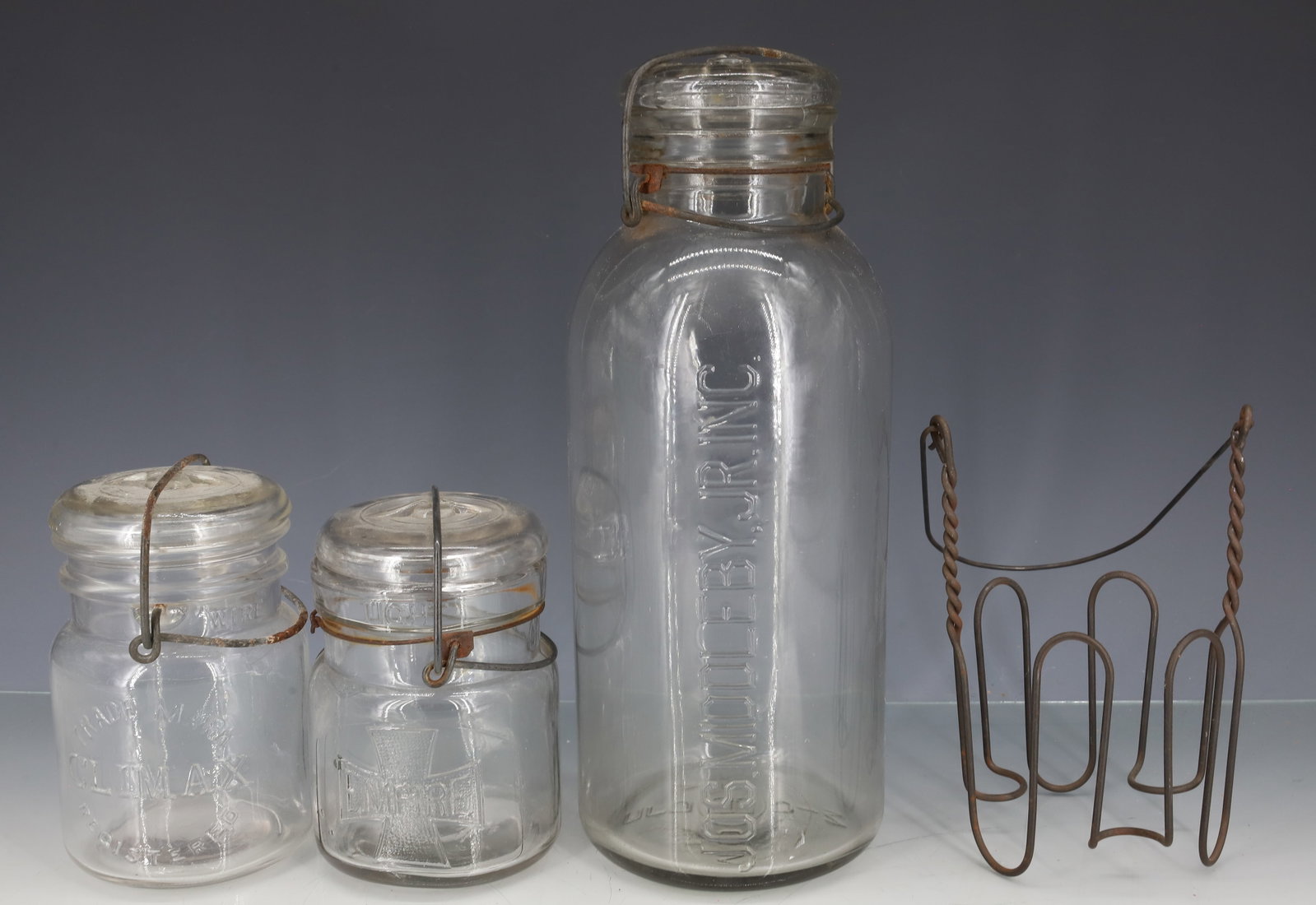LOT OF FRUIT JARS / WIRE HOLDER: INCLUDING: LARGE "JOS. MIDDLEBY, JR. INC." (BOSTON, MA) 10 3/4" H. "CLIMAX" AND "EMPIRE" BOTH WITH LIDS AND WIRE CLOSURES 4 3/4" AND 5 1/4" HEIGHTS. WITH, WIRE JAR / CANNING HOLDER. PLEASE READ CAREFU