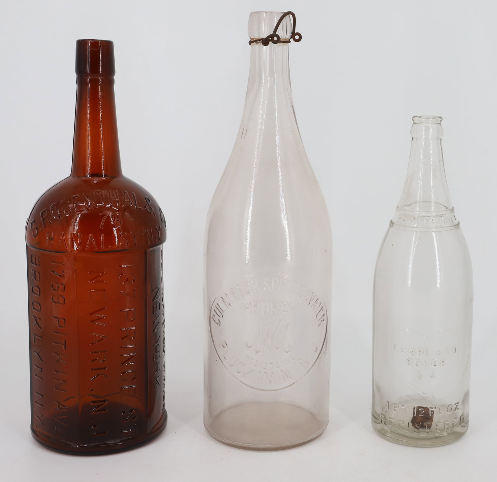 S. ROSENTHAL & CO. SIX-SIDED BOTTLE: LARGE AMBER BOTTLE WITH MULTIPLE ADDRESSES (NEW YORK, BROOKLYN AND NEWARK). 13 1/4" H. WITH, PLUCKAMIN, NJ SPRING WATER BOTTLE AND F. CIARDI & CO. (DOVER). PLEASE READ CAREFULLY - ITEMS MUST BE PAID