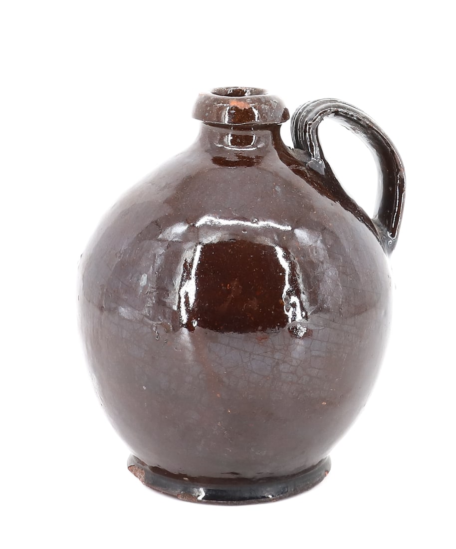 19TH CENTURY REDWARE JUG: SMALL SIZE, DARK GLAZE, WITH STRAP HANDLE - 6 1/2" H PLEASE READ CAREFULLY - ITEMS MUST BE PAID FOR THROUGH LIVE AUCTIONEERS OR WITH CASH OR CHECK IN PERSON - Terms for Purchasing and Shipping of
