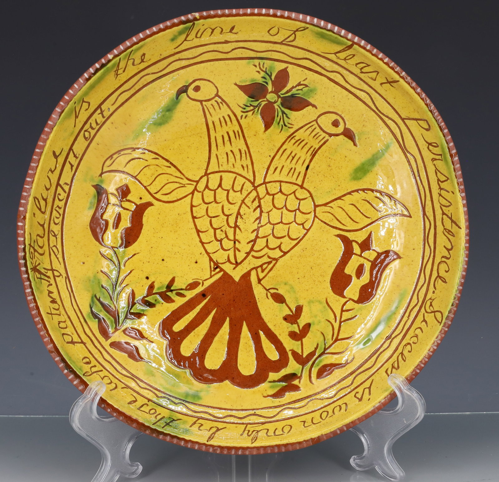 BREININGER POTTERY DECORATED PIE PLATE: DECORATED WITH BIRDS AND FLORAL, GERMAN VERSE AROUND EDGE, AND YELLOW AND GREEN GLAZE - MARKED AND DATED ON BACK 1976, 11 1/4" PLEASE READ CAREFULLY - ITEMS MUST BE PAID FOR THROUGH LIVE AUCTIONEERS