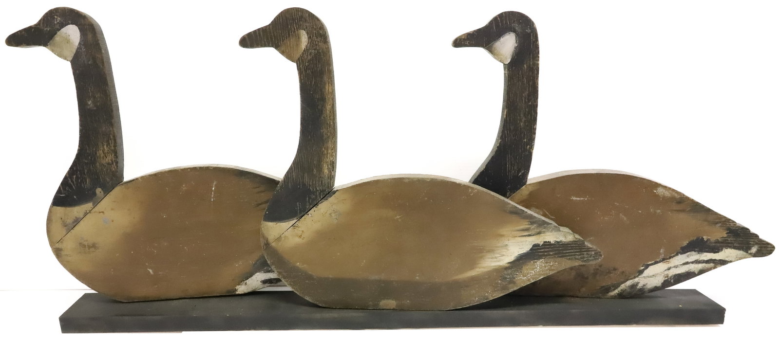 FOLK ART GOOSE CUTOUTS: (3) CARVED AND PAINTED GEESE ON HANDCRAFTED BLACK DISPLAY CASE - 20" X 46 1/2" PLEASE READ CAREFULLY - ITEMS MUST BE PAID FOR THROUGH LIVE AUCTIONEERS OR WITH CASH OR CHECK IN PERSON - Terms for Purch