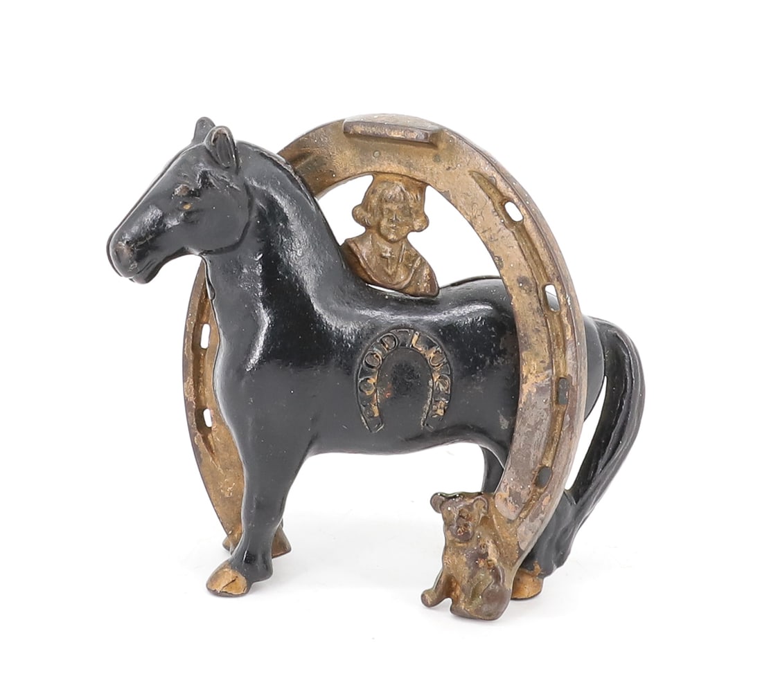 CAST IRON BUSTER BROWN BANK: STILL BANK WITH PAINTED SURFACE. HORSESHOE AND "GOOD LUCK". 4 1/4" H. PLEASE READ CAREFULLY - ITEMS MUST BE PAID FOR THROUGH LIVE AUCTIONEERS OR WITH CASH OR CHECK IN PERSON - Terms for Purchasing