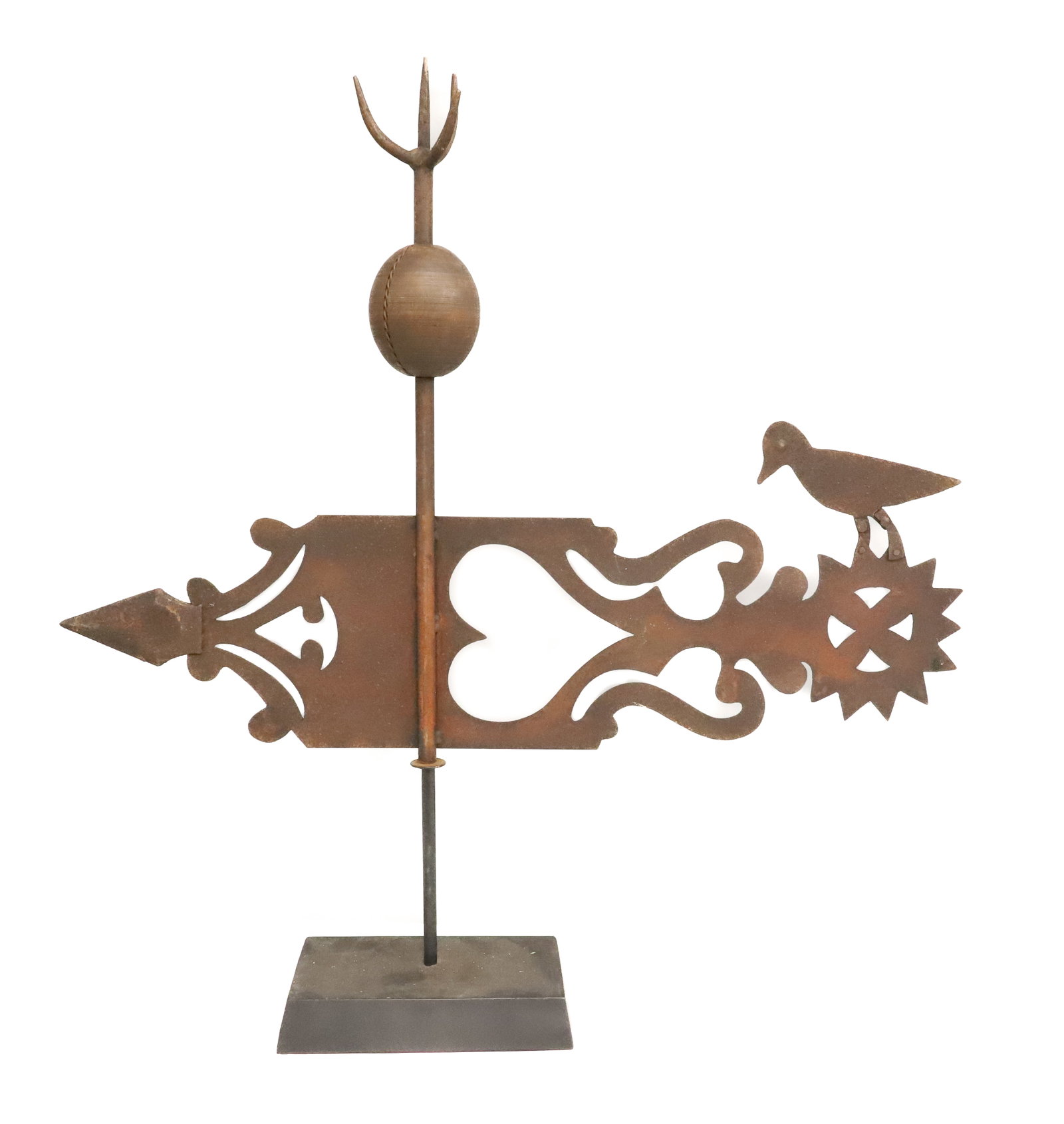 FOLK ART CUT-OUT METAL WEATHERVANE: BANNER-STYLE WITH HEART MOTIF. BIRD ATTACHED AT END. CENTRAL COPPER ROD WITH WOODEN BALL (WIRE COILED AROUND) AND FOUR IRON POINTS AT TOP. DISPLAYED ON CONTEMPORARY BASE. TOTAL HEIGHT 26 1/2" X 24