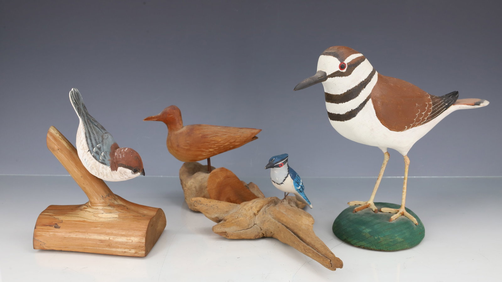 LOT OF (4) CARVED BIRDS: CARVED AND PAINTED WOODEN BIRDS ON BASES. ONE MRKD. ROSA LORD. LARGEST IS 10 1/4" L. PLEASE READ CAREFULLY - ITEMS MUST BE PAID FOR THROUGH LIVE AUCTIONEERS OR WITH CASH OR CHECK IN PERSON - Terms for