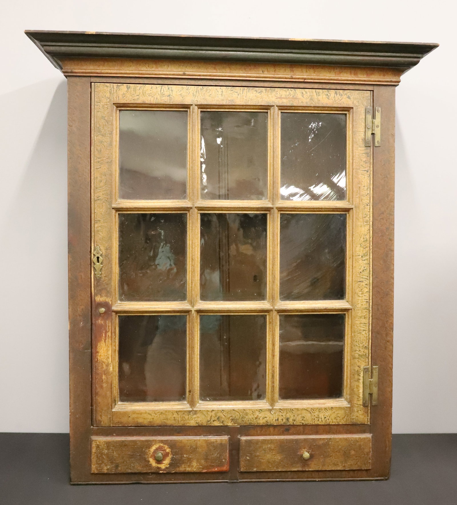 FINE PAINT DECORATED HANGING CUPBOARD: 9 GLASS PANES OVER 2 DRAWERS, INTERIOR SHELVES, VARIOUS COLOR PAINT DECORATION, IN YELLOW ORANGE, GREEN, BLACK, AND RED - H HINGES ON DOORS -POSSIBLY THE TOP TO AN OLD CUPBOARD - 41 1/2" X 31" X 10