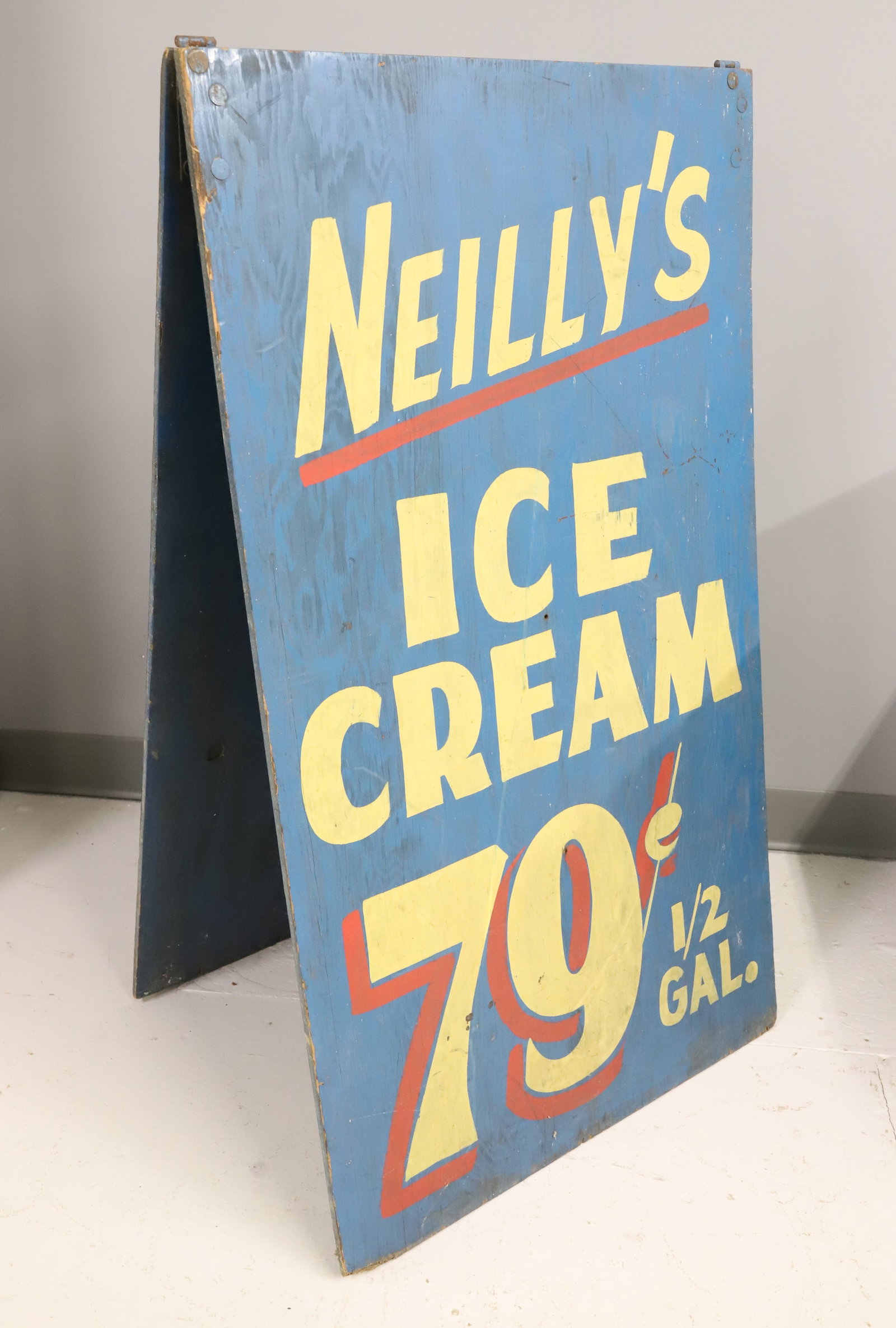 DOUBLE-SIDED SIDEWALK ADVERTISING SIGN: PAINTED WOOD "NEILLY'S ICE CREAM .79 1/2 GAL. 41" X 24". PLEASE READ CAREFULLY - ITEMS MUST BE PAID FOR THROUGH LIVE AUCTIONEERS OR WITH CASH OR CHECK IN PERSON - Terms for Purchasing and Shipping of