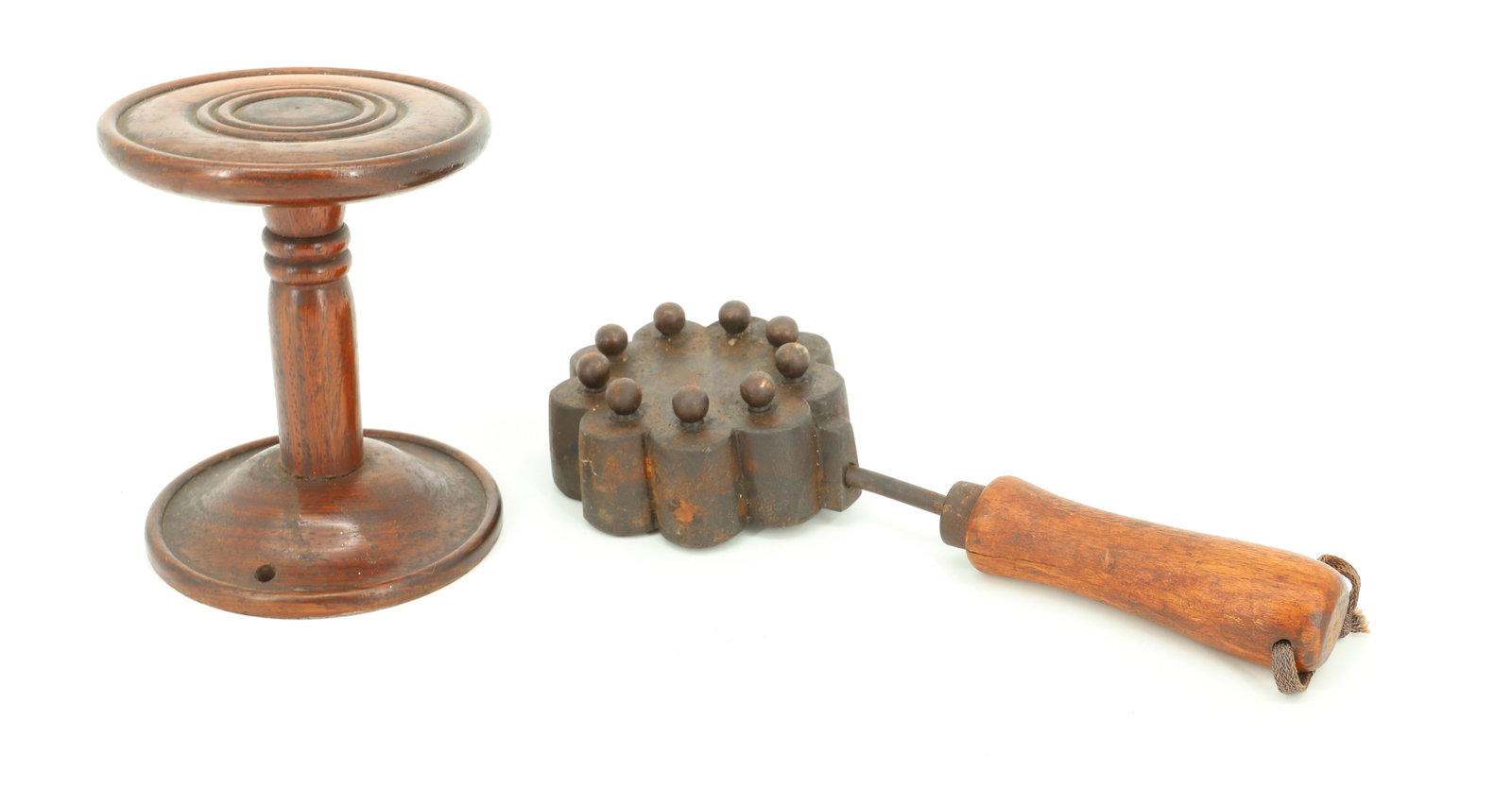WOODEN PEDESTAL AND HAT IRON: TURNED WOOD PEDESTAL 5" X 4". CAST IRON FLOWER HAT IRON W/ NINE BEADS. 10" L. PLEASE READ CAREFULLY - ITEMS MUST BE PAID FOR THROUGH LIVE AUCTIONEERS OR WITH CASH OR CHECK IN PERSON - Terms for