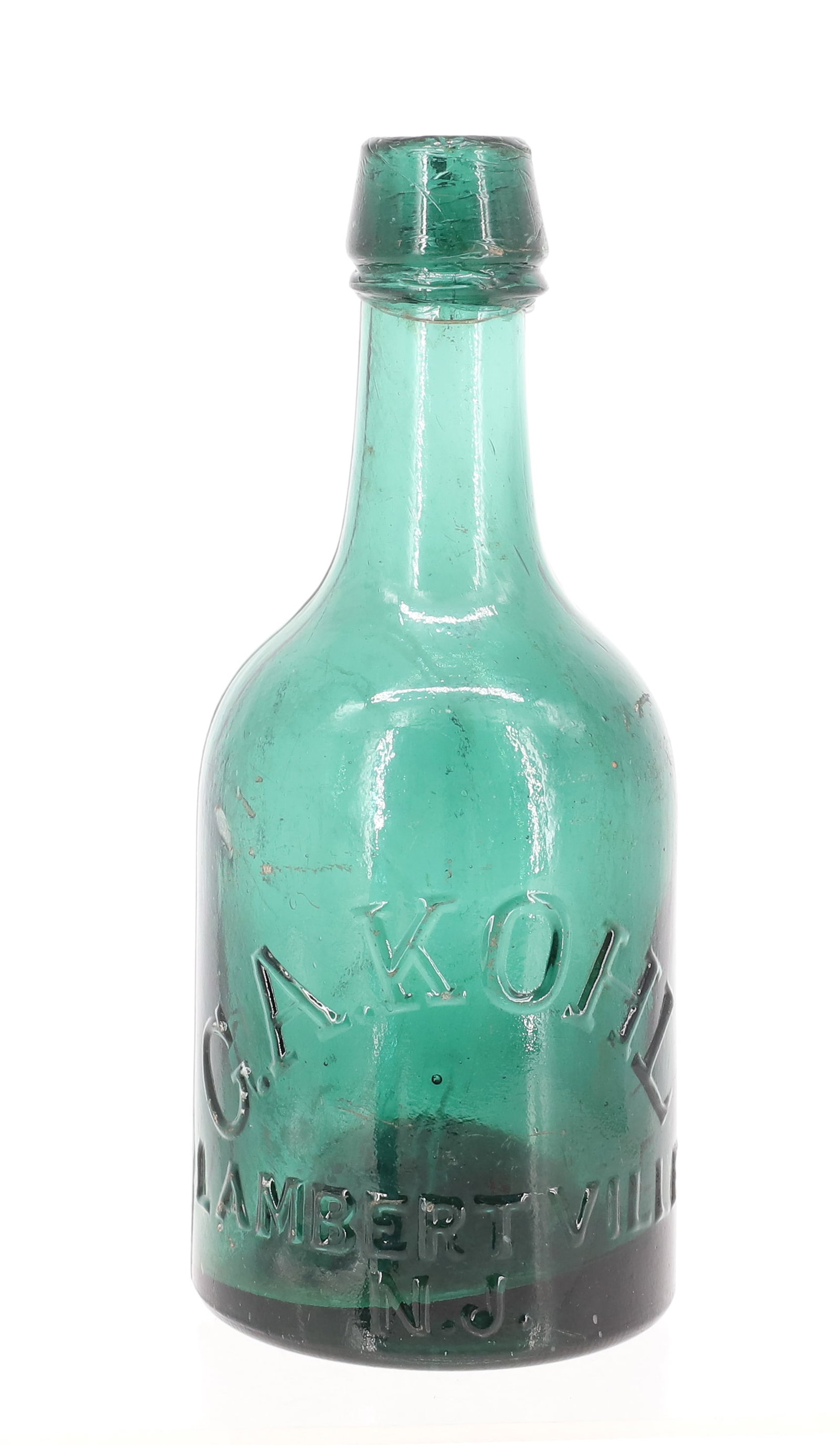 G.A. KOHL, LAMBERTVILLE, NJ BOTTLE: GREEN SQUAT BOTTLE " G.A. KOHL LAMBERTVILLE, N.J. " AND "K" ON BACK. IRON PONTIL. 7" H. PLEASE READ CAREFULLY - ITEMS MUST BE PAID FOR THROUGH LIVE AUCTIONEERS OR WITH CASH OR CHECK IN PERSON - Terms
