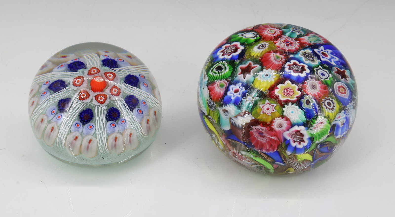 (2) VINTAGE GLASS PAPERWEIGHTS: LARGER WITH MILLEFIORI DESIGN. UNMARKED. 3 1/8" D. WITH, SMALLER LABELED "STRATHEARN, MADE IN SCOTLAND" 2 1/8" D. PLEASE READ CAREFULLY - ITEMS MUST BE PAID FOR THROUGH LIVE AUCTIONEERS OR WITH CASH