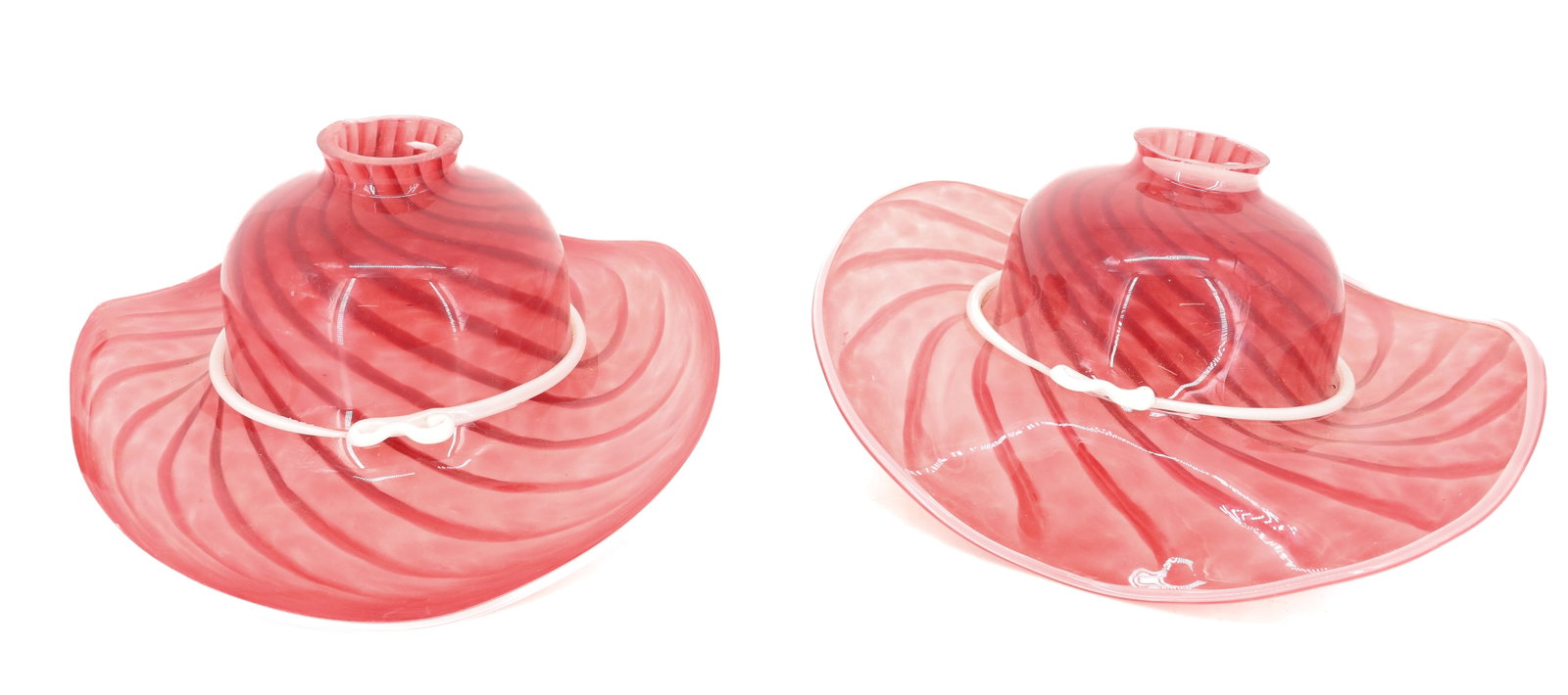 PAIR OF ART GLASS "HAT" SHADES: SWIRLED CRANBERRY GLASS WITH APPLIED GLASS WHITE "RIBBON. 12" X 11". PLEASE READ CAREFULLY - ITEMS MUST BE PAID FOR THROUGH LIVE AUCTIONEERS OR WITH CASH OR CHECK IN PERSON - Terms for Purchasing and 