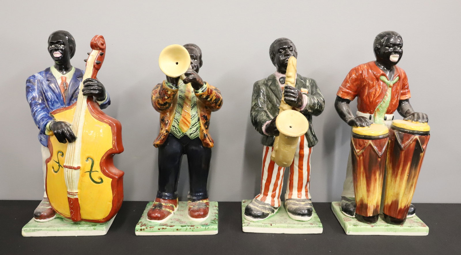 LOT OF (4) CERAMIC MUSICIANS: JAZZ MUSICIANS PAINTED IN VIBRANT COLORS. UNMARKED. LARGEST 12 3/4" H. PLEASE READ CAREFULLY - ITEMS MUST BE PAID FOR THROUGH LIVE AUCTIONEERS OR WITH CASH OR CHECK IN PERSON - Terms for Purchasing