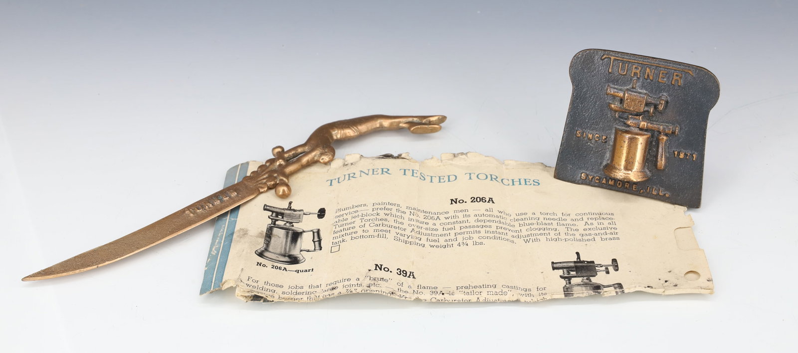 (2) TURNER TORCHES ADVERTISERS: BRONZE TURNER BLOW TORCH ADVERTISER AND LETTER OPENER 8 1/2" L. PLEASE READ CAREFULLY - ITEMS MUST BE PAID FOR THROUGH LIVE AUCTIONEERS OR WITH CASH OR CHECK IN PERSON - Terms for Purchasing and