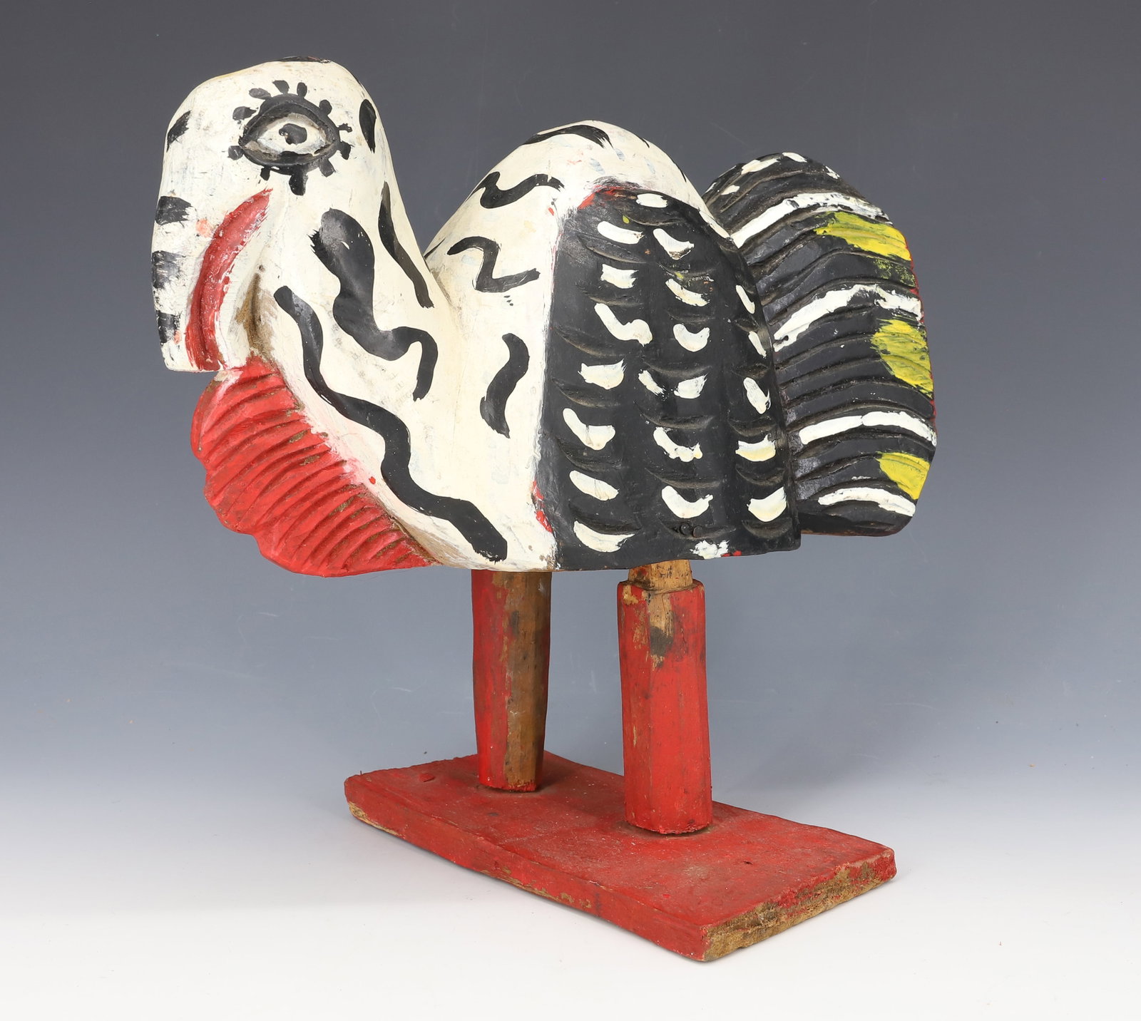 FOLK ART WOODEN TURKEY: BLACK/RED/WHITE/YELLOW PAINT ON RED BASE. UNSIGNED. 10" X 10 1/2". PLEASE READ CAREFULLY - ITEMS MUST BE PAID FOR THROUGH LIVE AUCTIONEERS OR WITH CASH OR CHECK IN PERSON - Terms for Purchasing and Sh