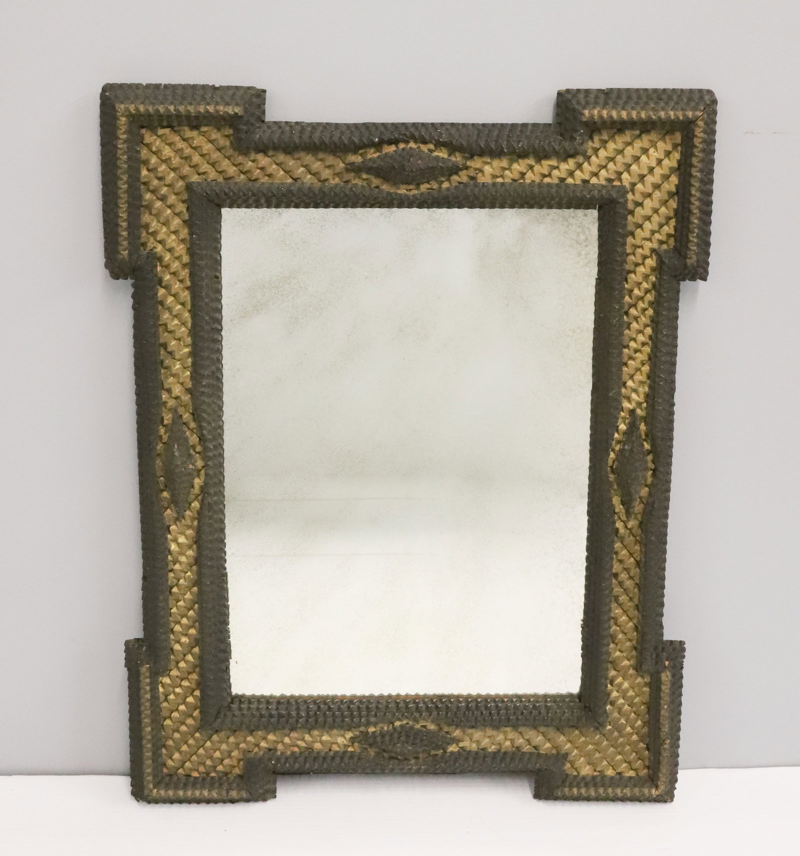 TRAMP ART MIRROR: CHIP CARVED WITH GOLD PAINTED ZIG ZAG PATTERN. 21" X 16". MIRROR IS 14 1/2" X 10 1/2". PLEASE READ CAREFULLY - ITEMS MUST BE PAID FOR THROUGH LIVE AUCTIONEERS OR WITH CASH OR CHECK IN PERSON - Terms