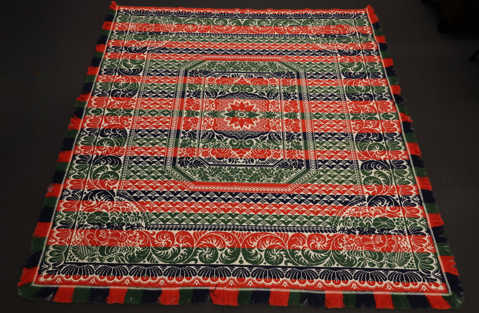 19TH C. FOUR-COLOR COVERLET: CENTRAL OCTAGONAL CARTOUCHE WITH EIGHT POINT STAR. GEOMETRICS, FLORAL AND LEAVES. FRINGE EDGE. 84" X 88". PLEASE READ CAREFULLY - ITEMS MUST BE PAID FOR THROUGH LIVE AUCTIONEERS OR WITH CASH OR CHECK 