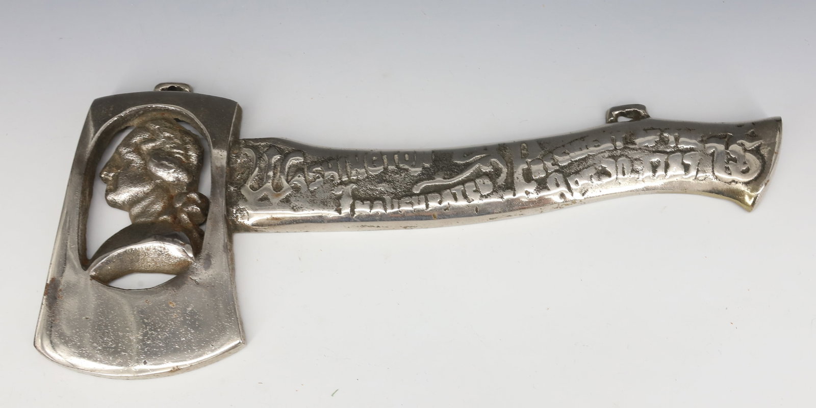 CAST IRON COMMEMORATIVE WASHINGTON AXE: NICKEL OVER CAST IRON. EMBOSSED HANDLE COMMEMORATING WASHINGTON'S INAUGURATION 1789. 11 1/2" L. PLEASE READ CAREFULLY - ITEMS MUST BE PAID FOR THROUGH LIVE AUCTIONEERS OR WITH CASH OR CHECK IN PERSON
