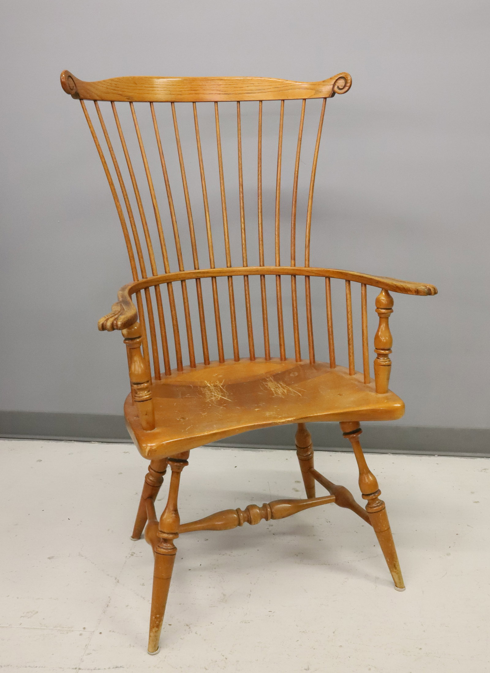DUCKLOE WINDSOR ARMCHAIR: HIGH-BACK WINDSOR ARMCHAIR. PEGGED/MORTISE CONSTRUCTION. DUCKLOE BROS COLONIAL REPRODUCTIONS, PORTLAND, PA. 45" X 27 1/2" X 17 1/2". PLEASE READ CAREFULLY - ITEMS MUST BE PAID FOR THROUGH LIVE