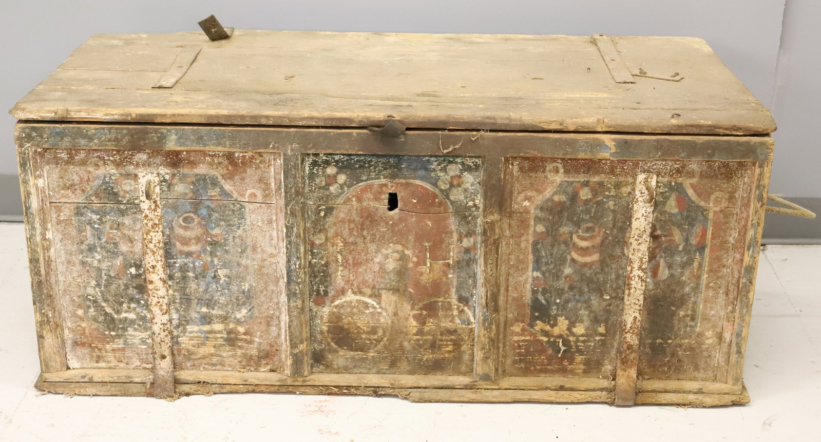 EARLY DECORATED WOODEN CHEST: THREE PANELED FRONT WITH IRON STRAPS. ROPE HANDLES ON SIDES. PLEASE READ CAREFULLY - ITEMS MUST BE PAID FOR THROUGH LIVE AUCTIONEERS OR WITH CASH OR CHECK IN PERSON - Terms for Purchasing and