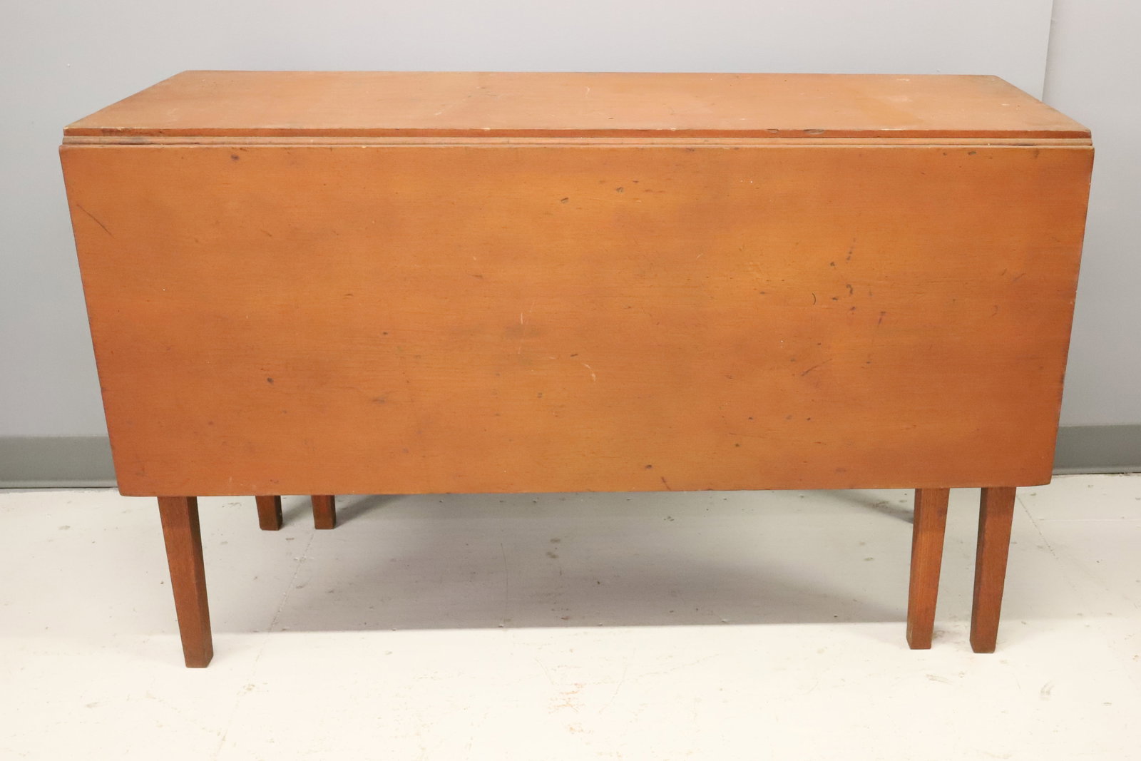 19TH C. PAINTED GATELEG TABLE: TAPERED LEGS WITH DROP LEAF ON EITHER SIDE. 29 1/2" X 54" X 48". (24" UNDERHANG CLEARANCE ON ENDS). PLEASE READ CAREFULLY - ITEMS MUST BE PAID FOR THROUGH LIVE AUCTIONEERS OR WITH CASH OR CHECK IN