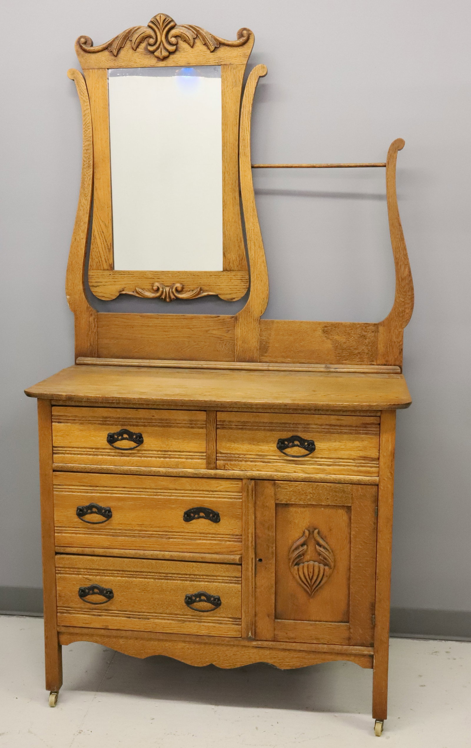 UNUSUAL OAK DRESSER / WASHSTAND COMBINATION: SWIVEL MIRROR AND TOWEL BAR OVER FOUR DRAWERS AND A DOOR. 72" X 39" X 18 1/2". PLEASE READ CAREFULLY - ITEMS MUST BE PAID FOR THROUGH LIVE AUCTIONEERS OR WITH CASH OR CHECK IN PERSON - Terms for