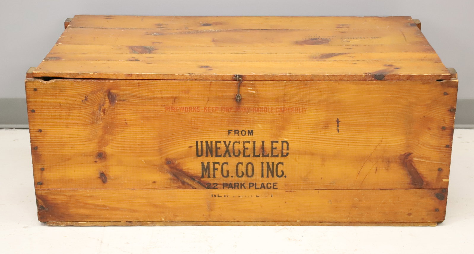 WOODEN FIREWORKS CRATE: FIREWORKS FROM UNEXCELLED MFG. CO. INC. 22 PARK PLACE, NEW YORK CITY. 15 1/4" X 37 1/2" X 21 1/4" (SHIPPED TO BANGOR, PA). PLEASE READ CAREFULLY - ITEMS MUST BE PAID FOR THROUGH LIVE AUCTIONEERS OR