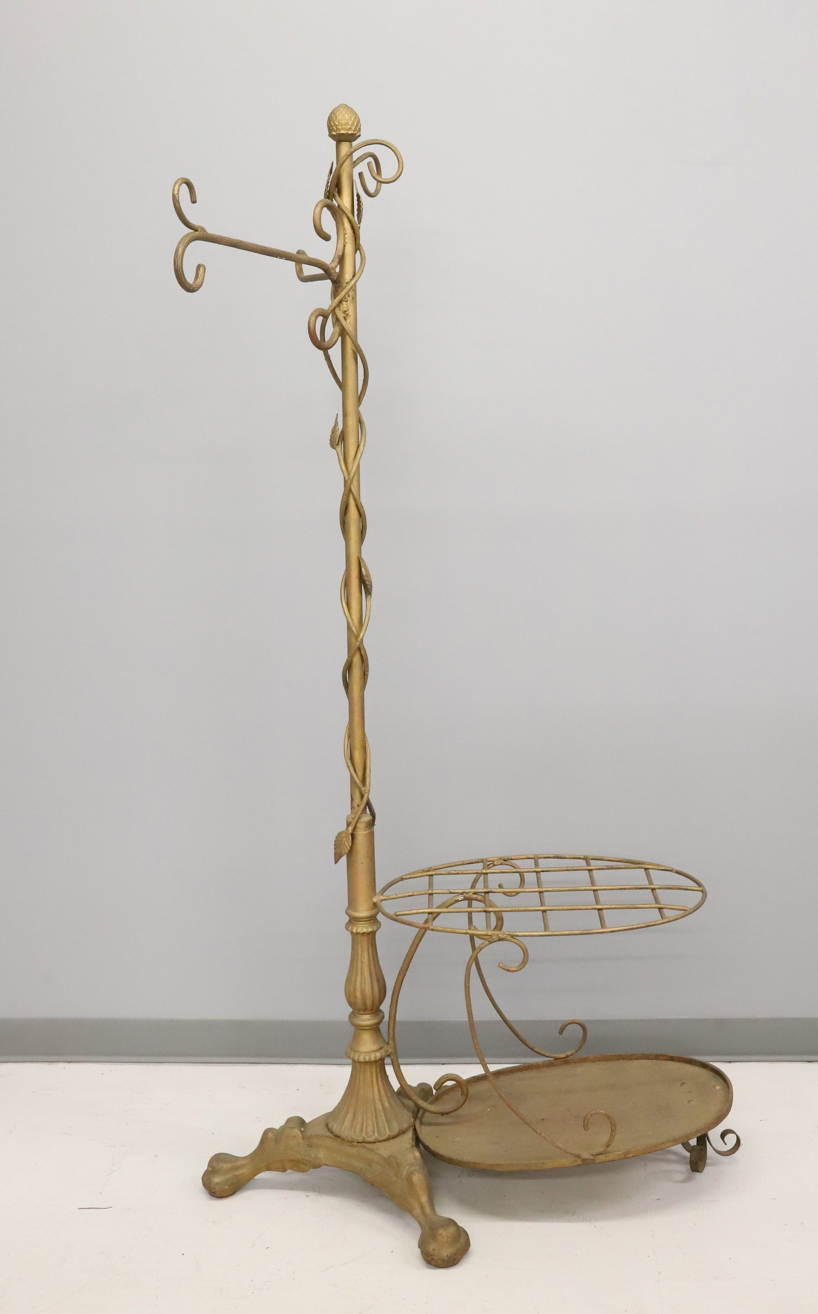 PAINTED CAST IRON UMBRELLA HOLDER / HAT TREE: GOLD PAINTED WITH VINES WRAPPING AROUND COLUMN. OVAL GRID FOR CANES / UMBRELLAS. 73" X 33". PLEASE READ CAREFULLY - ITEMS MUST BE PAID FOR THROUGH LIVE AUCTIONEERS OR WITH CASH OR CHECK IN PERSON - Te