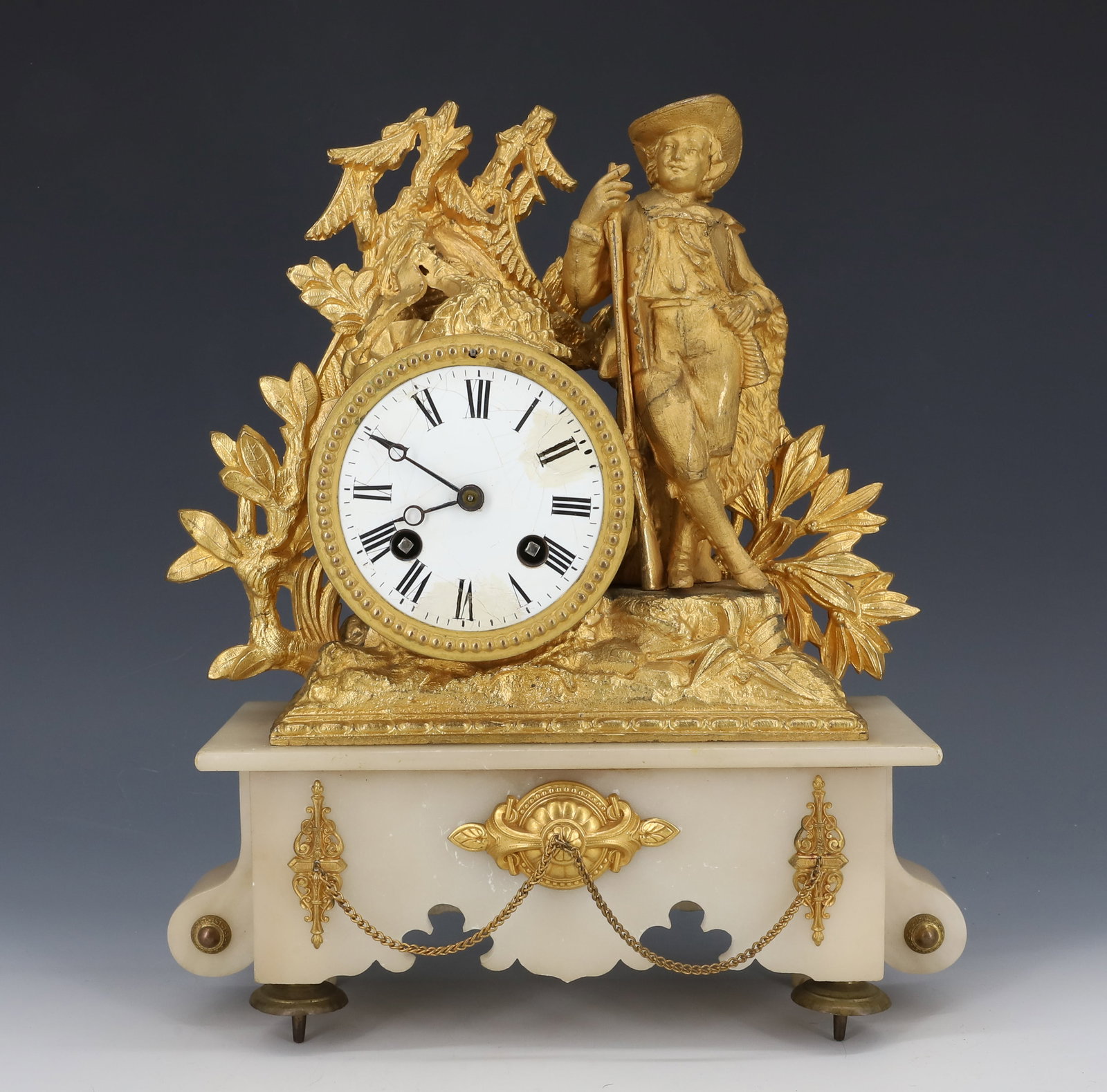 FRENCH GILT METAL CLOCK: CASTING OF MAN LEANING ON RIFLE. ONYX BASE WITH DECORATION. CLOCK HAS ENAMEL FACE. WITH KEY AND PENDULUM. 11 1/2" X 10". PLEASE READ CAREFULLY - ITEMS MUST BE PAID FOR THROUGH LIVE AUCTIONEERS OR