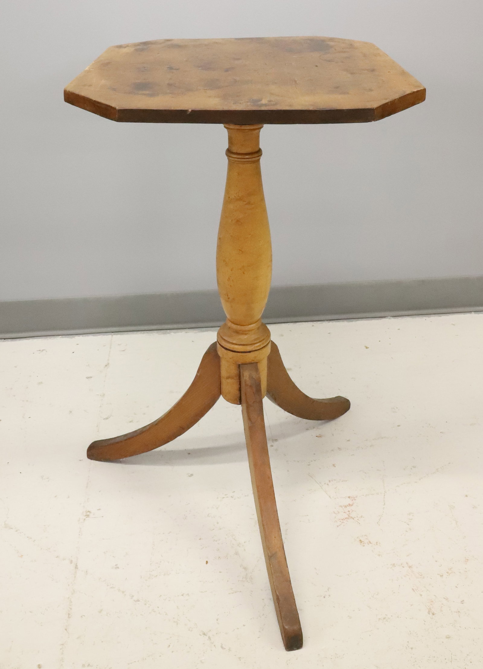 19TH C. CANDLE STAND: OCTAGONAL TOP ATTACHED TO TURNED COLUMN ON THREE LEGS. 29 1/4" X 20" X 17". PLEASE READ CAREFULLY - ITEMS MUST BE PAID FOR THROUGH LIVE AUCTIONEERS OR WITH CASH OR CHECK IN PERSON - Terms for
