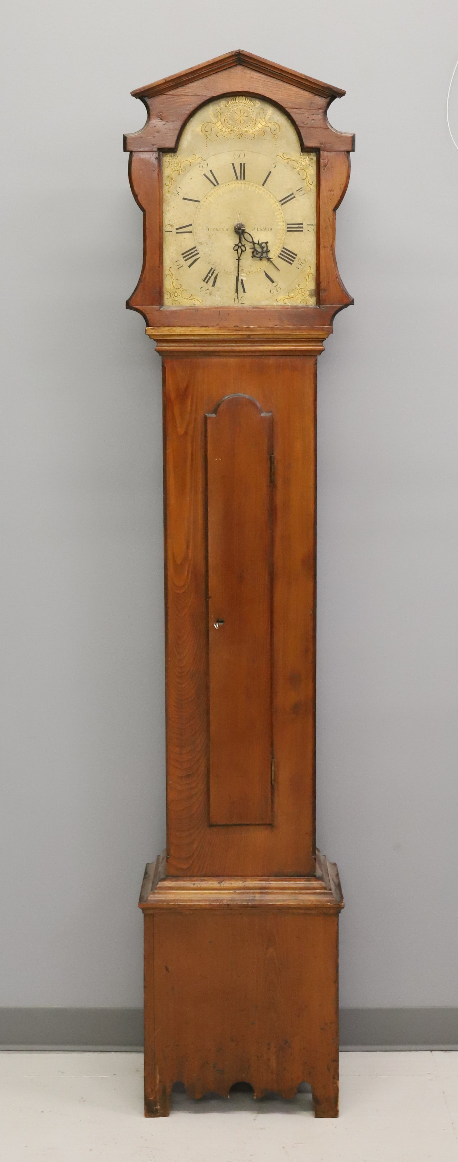 HOPKINS & LEWIS TALL CASE CLOCK: PAINTED WOODEN FACE. WOODEN WORKS. INCLUDES WEIGHTS AND PENDULUM. (LITCHFIELD, CT). 82 1/2" X 16" X 10". PLEASE READ CAREFULLY - ITEMS MUST BE PAID FOR THROUGH LIVE AUCTIONEERS OR WITH CASH OR CHECK
