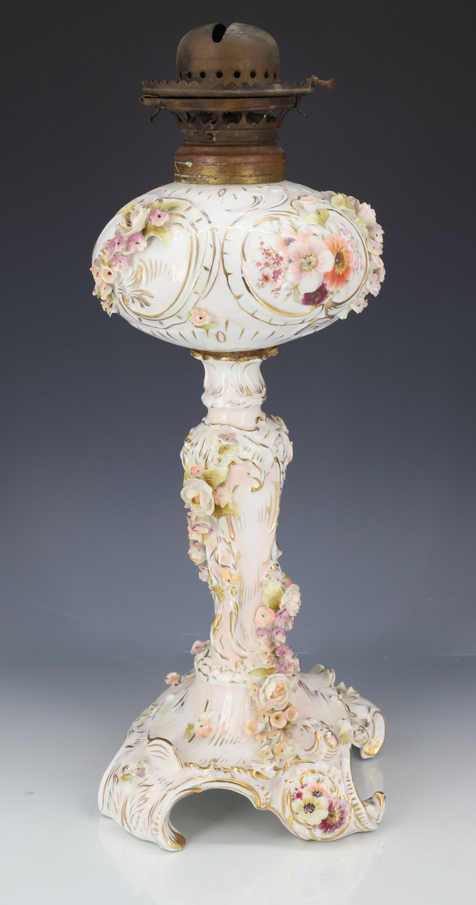 ANTIQUE PORCELAIN OIL LAMP: BANQUET-STYLE OIL LAMP. DRESDEN PORCELAIN HAND PAINTED WITH APPLIED FLOWERS. MRKD. ON BOTTOM. BASE IS 14" H.