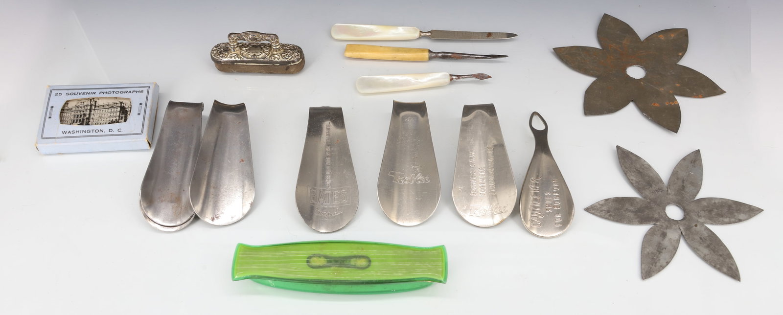 TIN QUILT PATTERNS AND MORE: (2) SIX-POINT TIN QUILT PATTERNS. WITH, ADVERTISING SHOE HORNS, CUTICLE IMPLEMENTS, SOUVENIR PHOTOGRAPHS OF WASHINGTON, DC AND MORE.