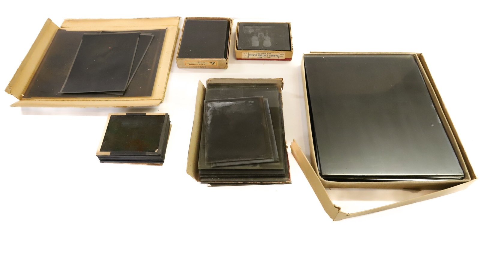 LOT OF ANTIQUE GLASS NEGATIVES: EVERYDAY VIEWS OF PEOPLE. GRAND CANYON, BUILDINGS, MONUMENTS, WOMAN IN CASKET AND MORE. LARGE GLASS NEGATIVES OF LITHOGRAPH PRINTS (SIMILAR TO CURRIER/IVES-TYPE). 8" X 10" SIZE. SMALLER ARE 3 1/4" X