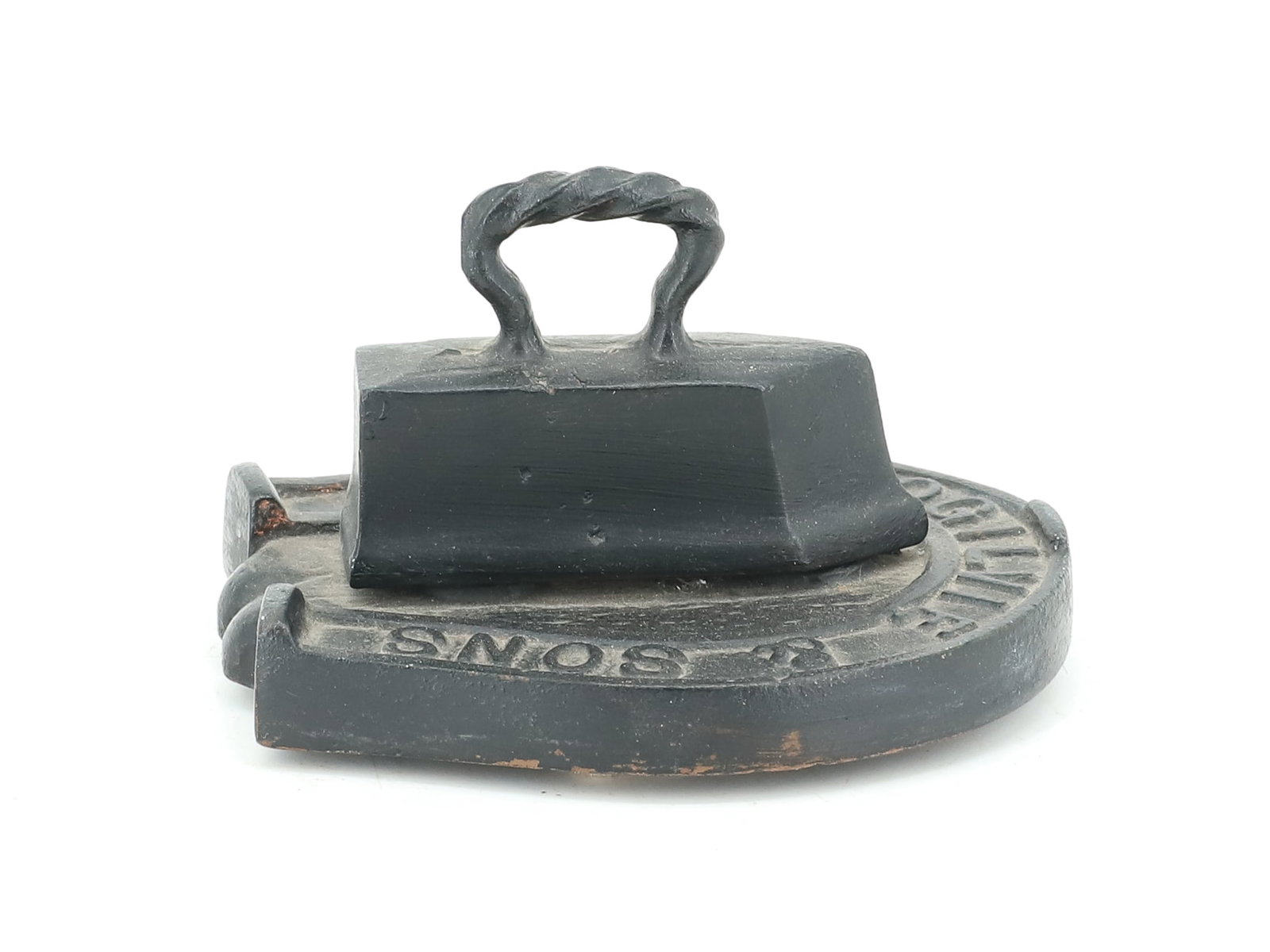 MINIATURE ADVERTISING TAILOR IRON PAPERWEIGHT: TAILOR IRON ATTACHED TO HORSESHOE DESIGN. "THOMAS OGILVIE & SONS" BLACK PAINTED SURFACE 4" L. PLEASE READ CAREFULLY - ITEMS MUST BE PAID FOR THROUGH LIVE AUCTIONEERS OR WITH CASH OR CHECK IN PERSON - 