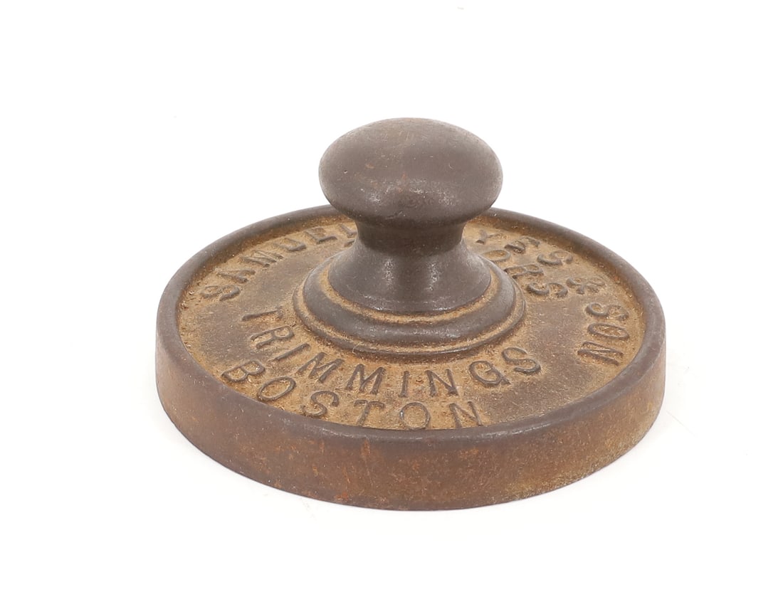 ADVERTISING SMOOTHING IRON: SMOOTHING TYPE IRON OR PAPERWEIGHT. "SAMUEL NOYES & SON, TAILORS TRIMMINGS BOSTON" SMOOTH BOTTOM 3 1/2" D. PLEASE READ CAREFULLY - ITEMS MUST BE PAID FOR THROUGH LIVE AUCTIONEERS OR WITH CASH OR CHECK