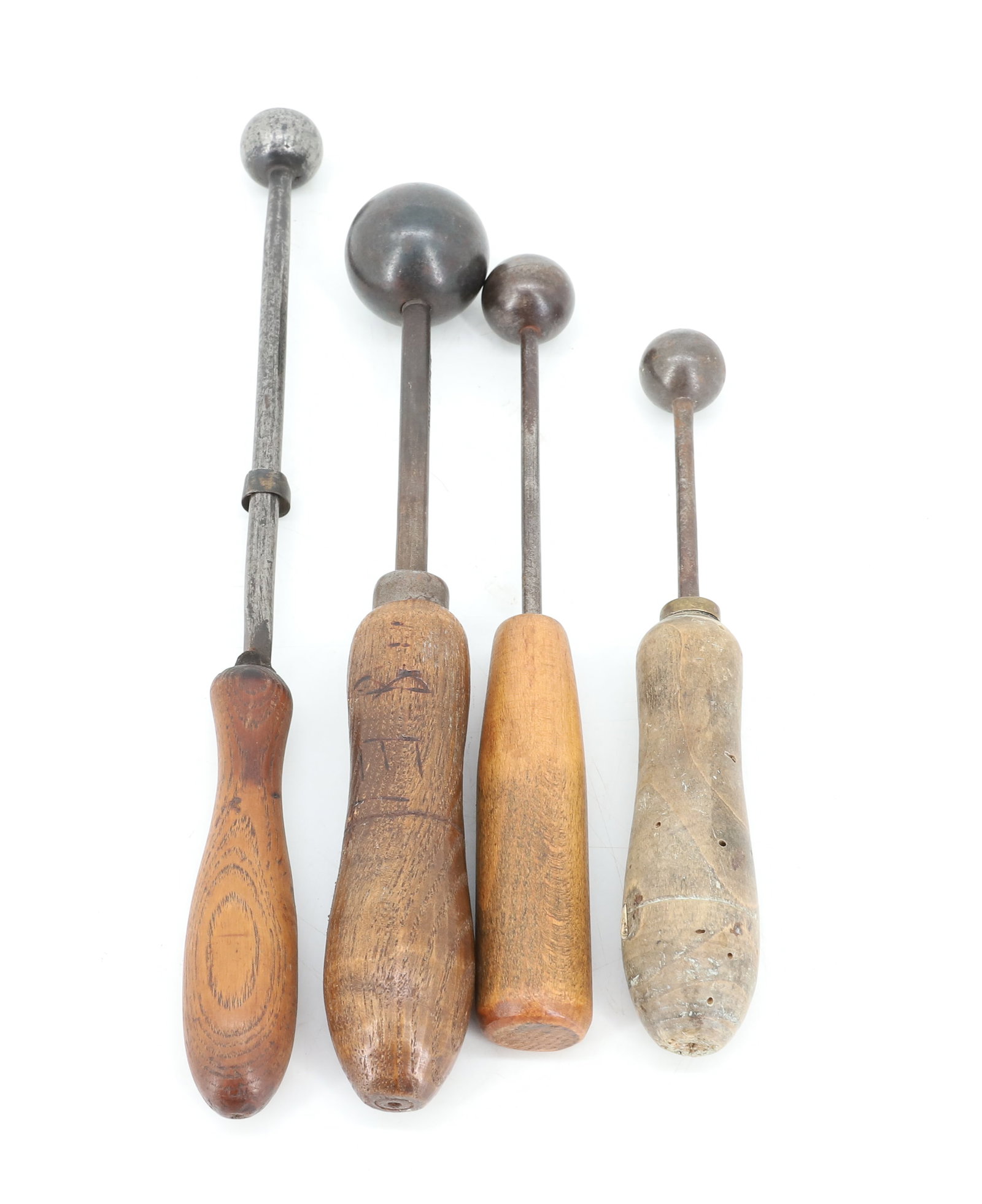 LOT OF BALL IRONS: FOUR IRON BALLS WITH WOODEN HAND GRIPS. LARGEST 1 3/8" D. PLEASE READ CAREFULLY - ITEMS MUST BE PAID FOR THROUGH LIVE AUCTIONEERS OR WITH CASH OR CHECK IN PERSON - Terms for Purchasing and Shipping of