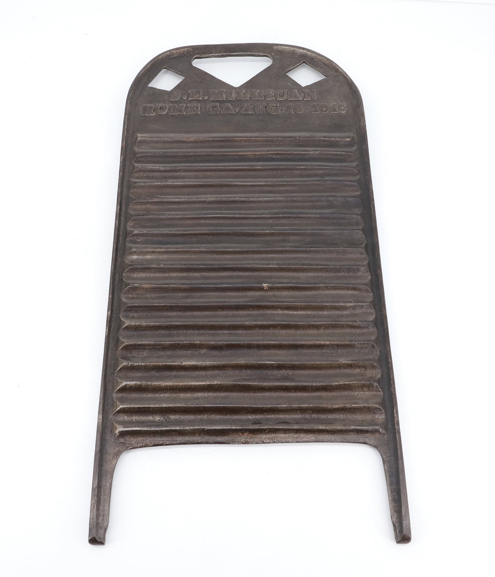 CAST IRON "ROME, GA" WASHBOARD: CAST BOARD EMBOSSED "C.E.MILLICAN, ROME GA, AUG.16.1915" CUT-OUT DECORATION AT TOP. 21 3/4" X 10 1/4". PLEASE READ CAREFULLY - ITEMS MUST BE PAID FOR THROUGH LIVE AUCTIONEERS OR WITH CASH OR CHECK IN