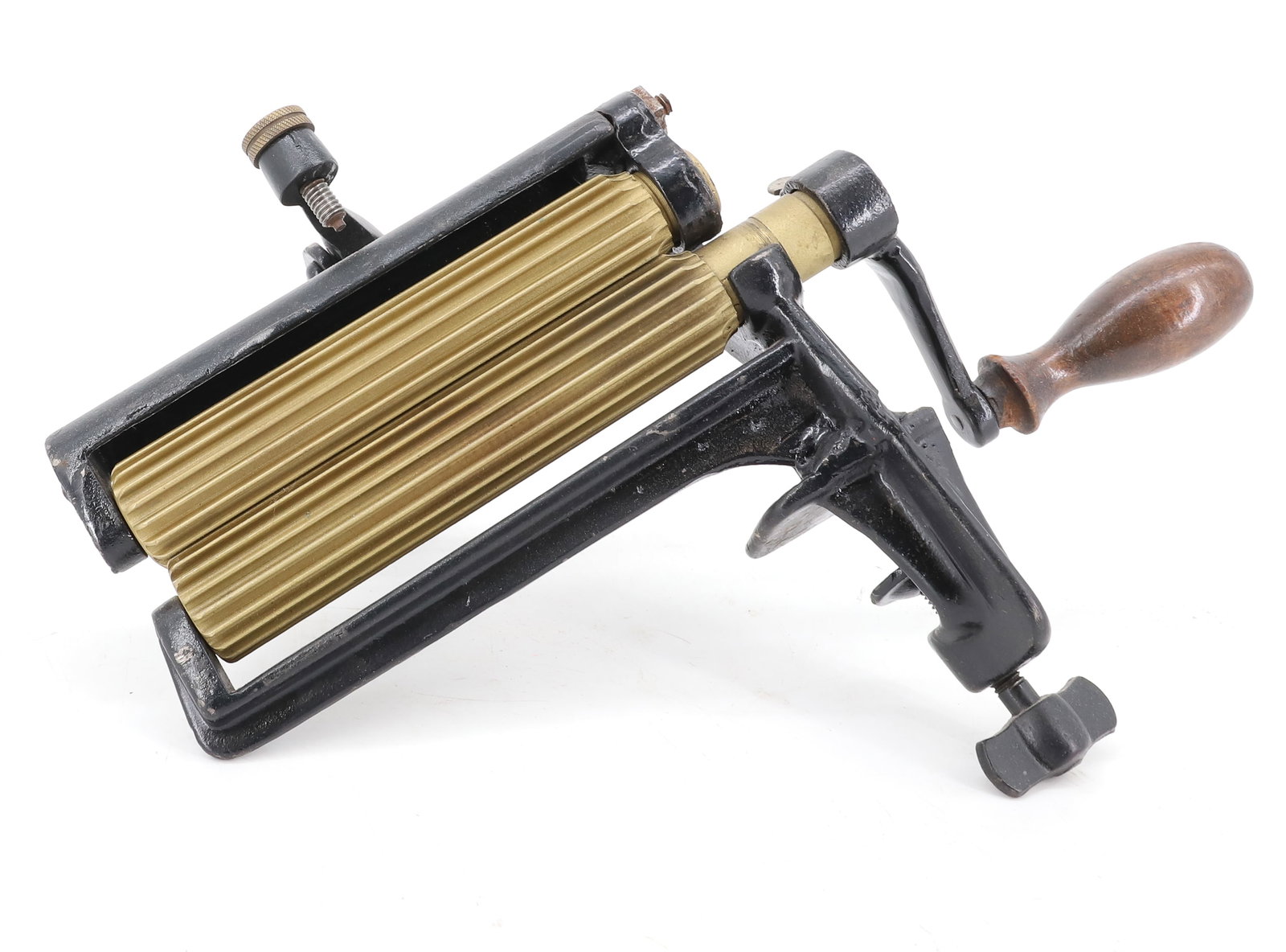 CLAMP-ON FLUTING MACHINE: BLACK PAINTED CAST IRON WITH BRASS ROLLERS. 6" L. UNMARKED. PLEASE READ CAREFULLY - ITEMS MUST BE PAID FOR THROUGH LIVE AUCTIONEERS OR WITH CASH OR CHECK IN PERSON - Terms for Purchasing and Shipping 