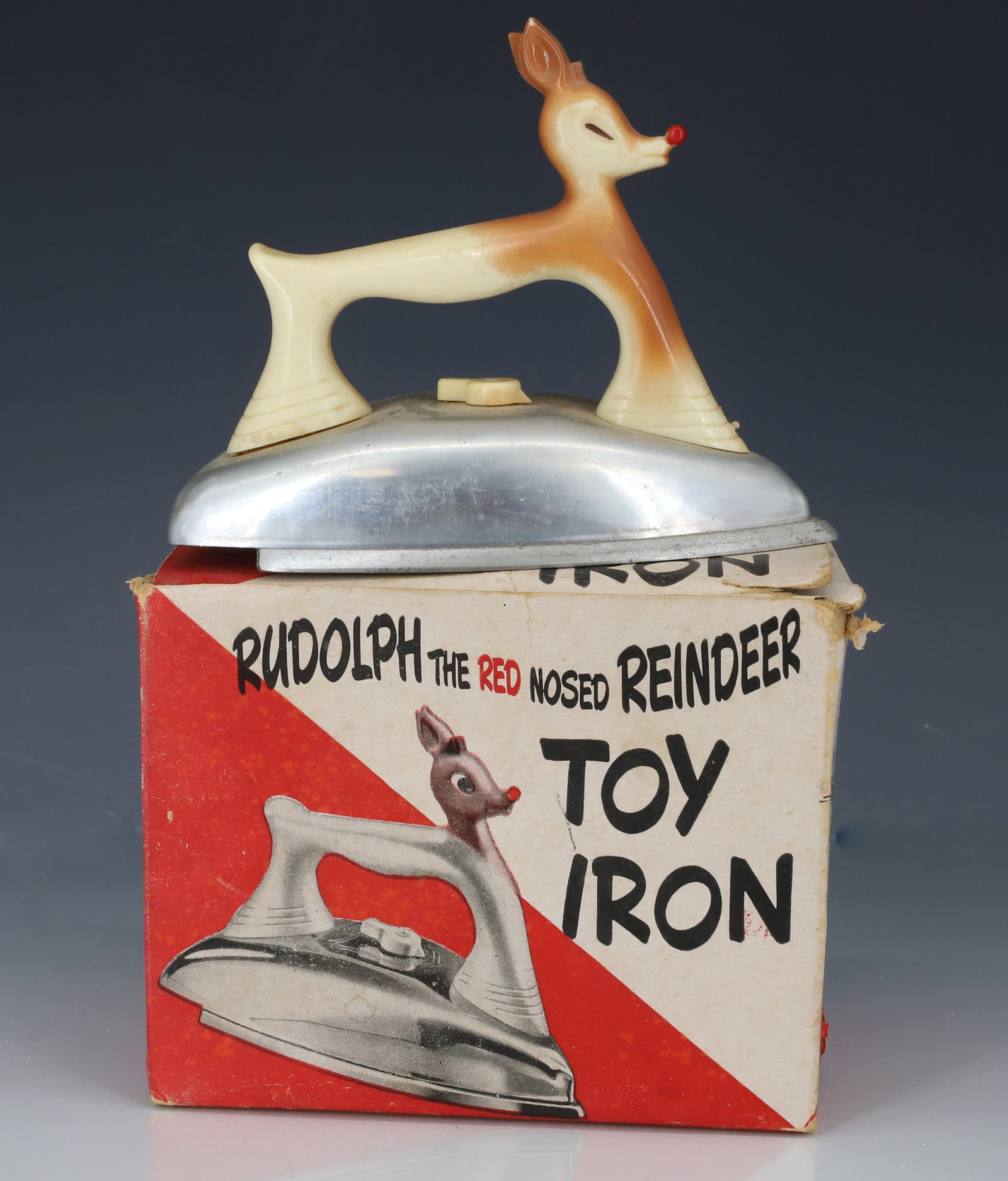 RUDOLPH TOY IRON W/ BOX: ALUMINUM WITH MOLDED PLASTIC HANDLE. 5 1/2" L. WITH ORIGINAL BOX. E.J. KAHN CO. CHICAGO. PLEASE READ CAREFULLY - ITEMS MUST BE PAID FOR THROUGH LIVE AUCTIONEERS OR WITH CASH OR CHECK IN PERSON - Terms