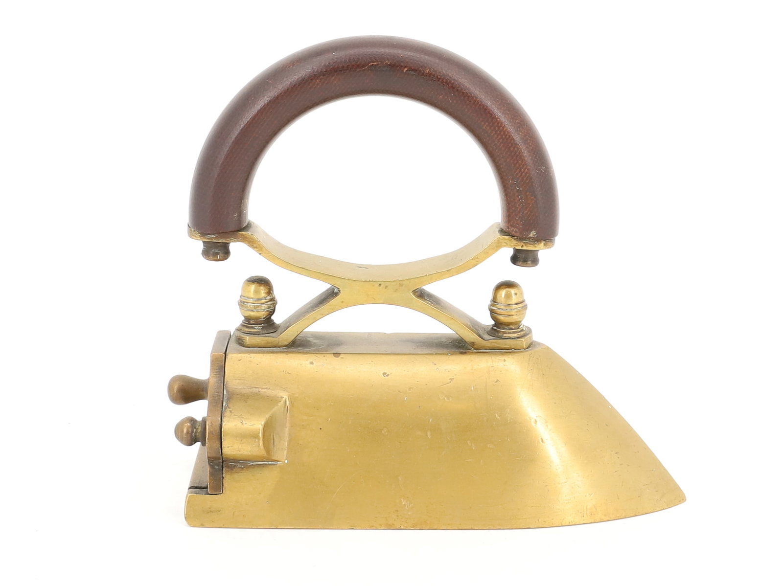 SMALL SIZE BRASS PRESSING IRON: DROP-IN-BACK SLUG IRON (WITH SLUG). ACORN-STYLE FINIALS. ARCHED WOODEN HANDLE. 5" H. PLEASE READ CAREFULLY - ITEMS MUST BE PAID FOR THROUGH LIVE AUCTIONEERS OR WITH CASH OR CHECK IN PERSON - Terms