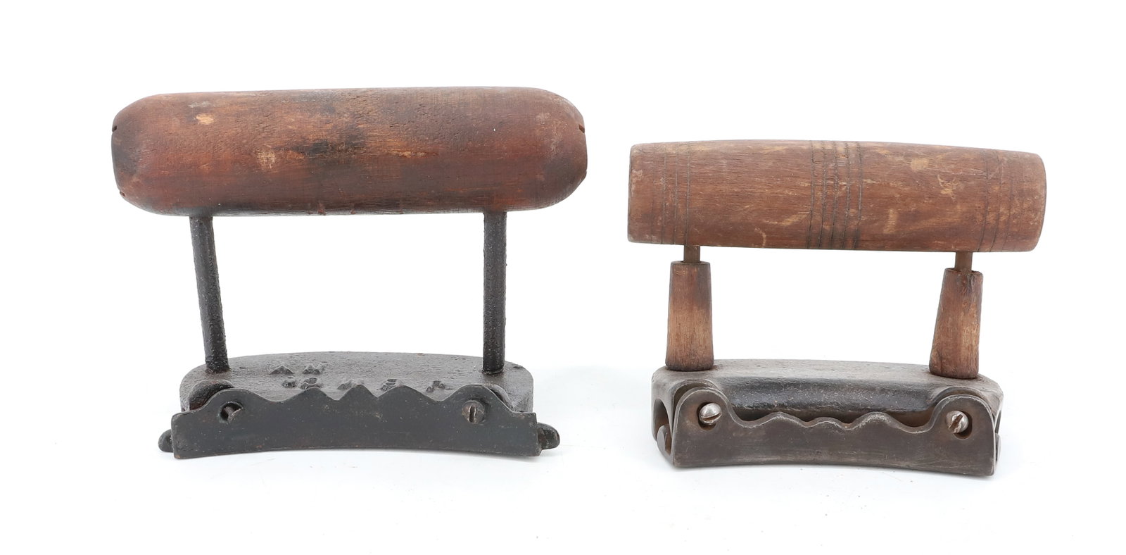 (2) CAST IRON HAT IRONS: CURVED BODIES WITH WOODEN HAND GRIPS. ONE MRKD. "JBM CO., NY" 3 7/8" TO 4" LENGTHS. PLEASE READ CAREFULLY - ITEMS MUST BE PAID FOR THROUGH LIVE AUCTIONEERS OR WITH CASH OR CHECK IN PERSON - Terms for