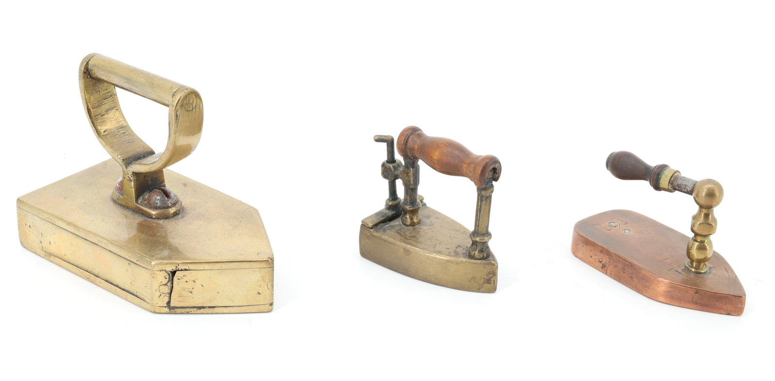 LOT OF (3) SMALL SIZE FLAT IRONS: INCLUDING: BRASS FLAT IRON WITH APPLIED HANDLE. SMALL SIZE COPPER FLAT IRON WITH FRONT POST AND WOODEN HANDLE. EARLY MINIATURE BOX IRON WITH REAR LIFT-GATE. 2 1/4" TO 4 1/2" LENGTHS. PLEASE READ CAREF