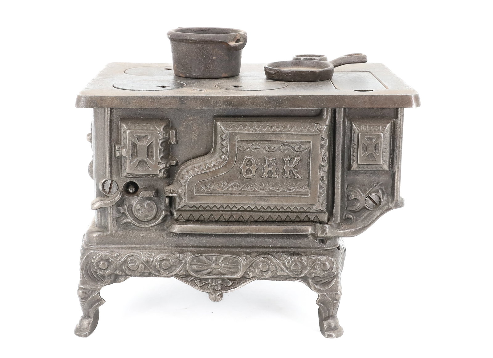 KENTON CAST IRON TOY STOVE: MARKED; OAK ON DOOR, 4 BURNER TOP, FIGURAL BASE - CAST IRON PAN AND POT, 5 1/4" X 7" X 4 3/4" PLEASE READ CAREFULLY - ITEMS MUST BE PAID FOR THROUGH LIVE AUCTIONEERS OR WITH CASH OR CHECK IN PERSON -