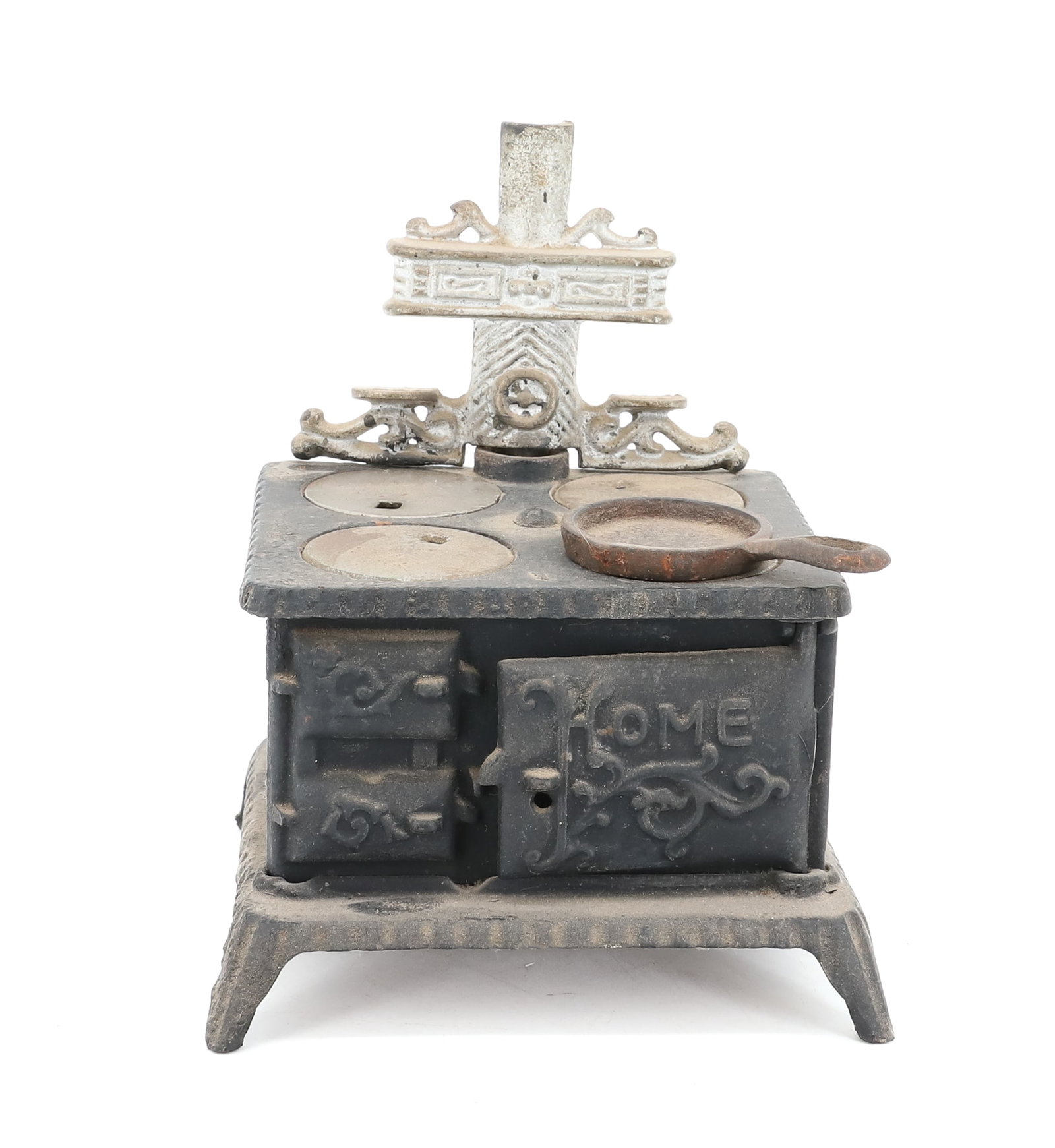 MINIATURE TOY STOVE: CAST IRON, 4 BURNER STOVE, MARKED; HOME ON DOOR - SILVER PAINTED HIGHLIGHTS WITH FRY PAN, 6" X 4 3/4" X 4 1/2" PLEASE READ CAREFULLY - ITEMS MUST BE PAID FOR THROUGH LIVE AUCTIONEERS OR WITH CASH OR