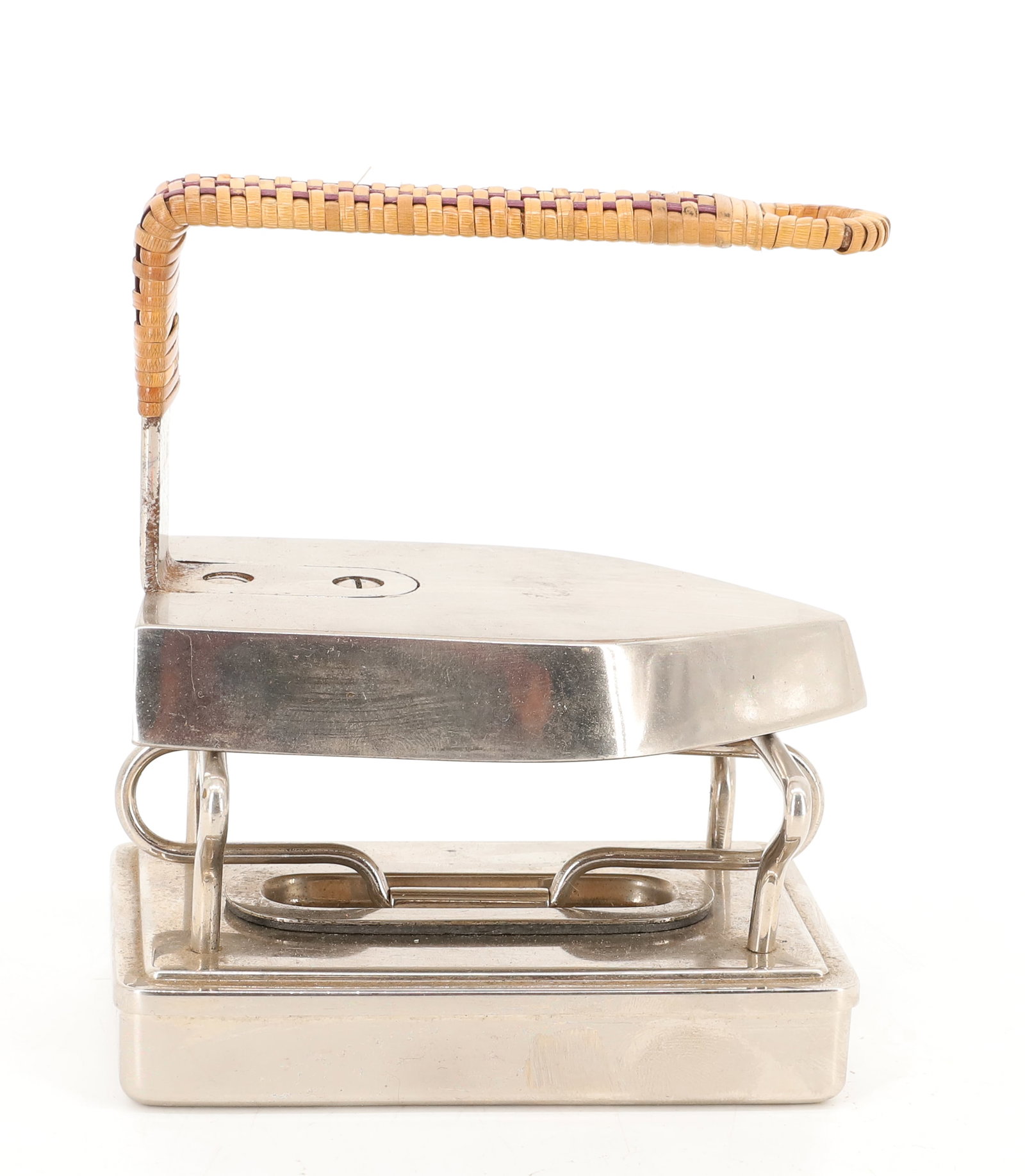 SAD IRON WITH HEATER: NICKEL IRON WITH REAR ATTACHED HANDLE. WICKER HAND GRIP COVER. WITH, HEATING BASE. 4 1/2" L. PLEASE READ CAREFULLY - ITEMS MUST BE PAID FOR THROUGH LIVE AUCTIONEERS OR WITH CASH OR CHECK IN PERSON - T